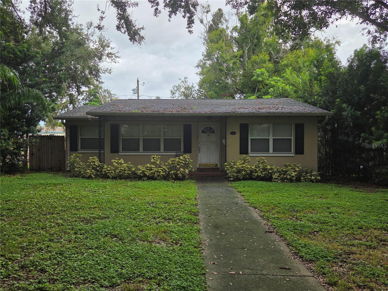 INVESTORS OR BUILD NEW. Many homes in the neighborhood are being torn down and large homes being built. But this home coud be renovated in this amazing location on this tree lined street. This 3 bedroom 2 bath home is dated but in great condition and ready for someone to put some work into it. Roof replaced 2022, a/c 2019 and a newer back wooden deck. There is lots of portential. Very livable now and walking distance to shops and restaurants. There are many new builds in the area so that is an option too. Come check it out. Outside looks tired but inside does not. Make this your new home.