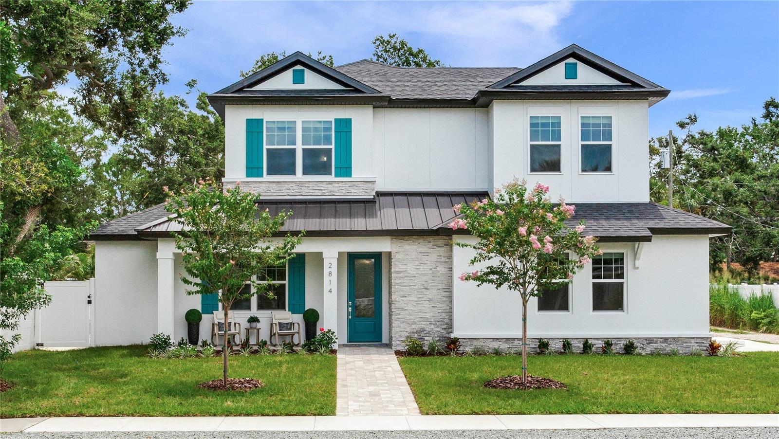 Experience the best of Gulfport living in this brand-new, high-and-dry construction, located in a no-flood zone and just a block from the vibrant downtown. This spacious 4-bedroom, 4-bath home with a 2-car garage is perfectly situated on an oversized corner lot. Step into an entertainer's paradise with a spacious open floor plan centered around a magnificent ten-foot quartz kitchen island. Enjoy movie nights in your home theater, tackle projects in your dedicated home office, retreat to the convenient first-floor primary suite featuring a floor to ceiling spa-inspired wet room, or host guests in the two upstairs en-suite bedrooms. Outside, a sparkling custom saltwater pool provides the perfect oasis. With multiple parks, Boca Ciega Bay, and an array of restaurants all within walking distance, your lifestyle options are endless. Start your day with coffee on the front porch and end it with an evening dip in your custom pool by the covered lanai.