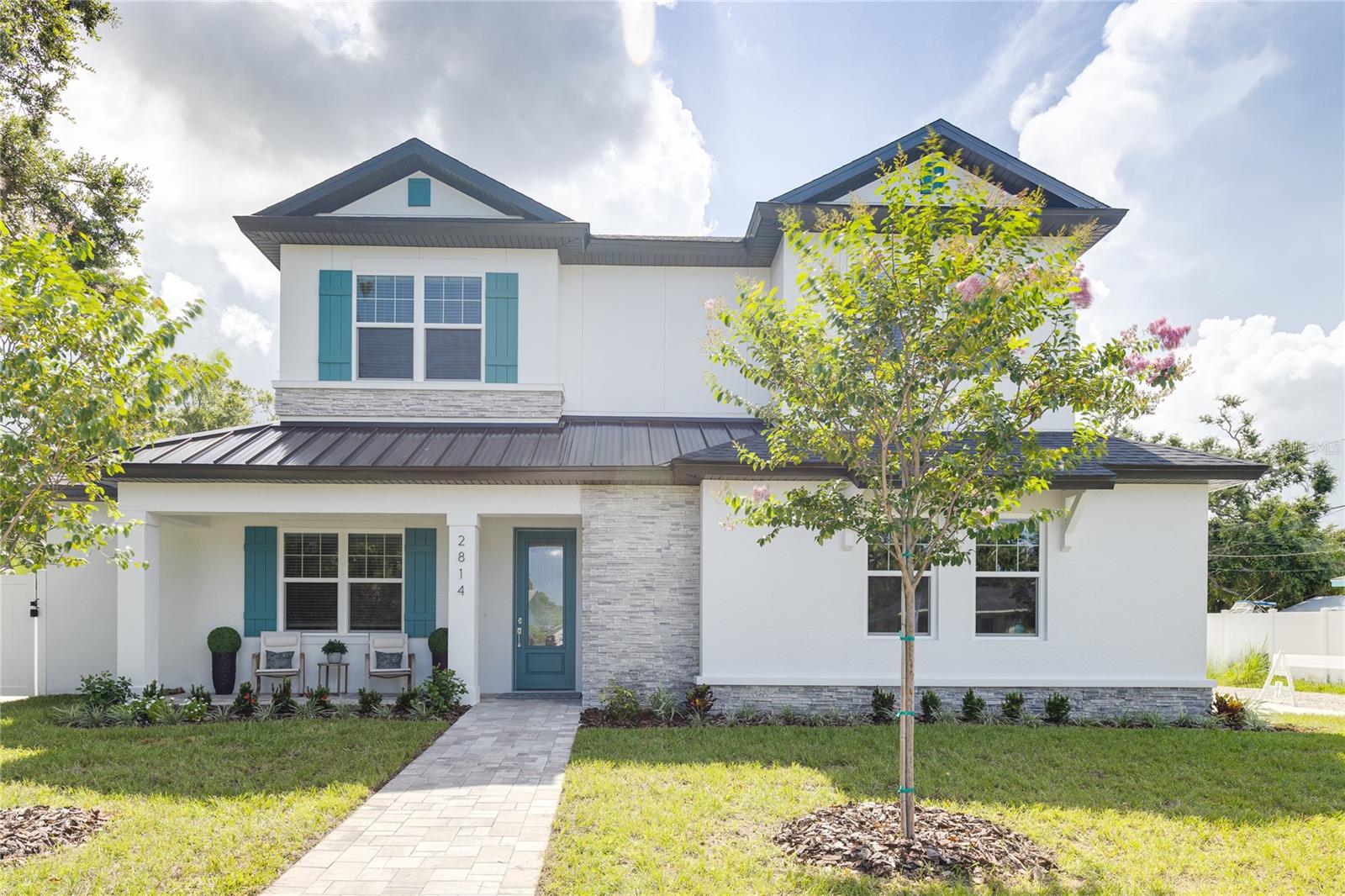Experience the best of Gulfport living in this brand-new, high-and-dry construction, located in a no-flood zone and just a block from the vibrant downtown. This spacious 4-bedroom, 4-bath home with a 2-car garage is perfectly situated on an oversized corner lot. Step into an entertainer's paradise with a spacious open floor plan centered around a magnificent ten-foot quartz kitchen island. Enjoy movie nights in your home theater, tackle projects in your dedicated home office, retreat to the convenient first-floor primary suite featuring a floor to ceiling spa-inspired wet room, or host guests in the two upstairs en-suite bedrooms. Outside, a sparkling custom saltwater pool provides the perfect oasis. With multiple parks, Boca Ciega Bay, and an array of restaurants all within walking distance, your lifestyle options are endless. Start your day with coffee on the front porch and end it with an evening dip by the covered lanai.