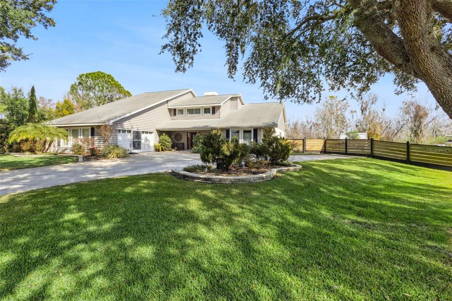 One or more photo(s) has been virtually staged. This exceptional WATERFRONT RESIDENCE has been thoughtfully reimagined with over $375K in high-end upgrades, creating a  turnkey luxury retreat with NO HOA and NO REAR NEIGHBORS. The transformation is anchored by a $105K open-concept kitchen remodel featuring custom Wellborn cabinetry, an oversized island crafted from exotic Macaubas Fantasy quartzite, a full suite of GE Café appliances, a 36” commercial-style gas range, dedicated coffee and wine bars, and generous seating for up to 15—ideal for entertaining. Additional enhancements include a newly added propane gas system, beautifully updated bathrooms with refined marble finishes and spa-inspired features, wide-plank wood-look ceramic tile throughout the main living areas, custom built-ins, a redesigned staircase, and waterproof laminate flooring on the second level. The spa-like primary bath is a true showpiece, appointed with authentic ITALIAN MARBLE FLOORING and walls, a jetted soaking tub crowned by a $3,600 crystal chandelier, digital shower controls with rain heads and body sprays, designer lighting, and a luxury smart bidet with touchless, sensor-activated functionality. A $73K investment in ANDERSEN REPLACEMENT WINDOWS and sliding glass doors enhances energy efficiency, durability, and comfort throughout the home, complemented by fresh interior and exterior paint, enhanced landscaping, and a newly added dedicated electrical panel at the shed providing expanded, property-wide electrical access. The property includes a 50-amp, 220-volt electrical service suitable for RV hookup. Thoughtfully designed for both everyday living and entertaining, the home also features custom digital LED exterior lighting throughout, allowing effortless holiday displays, seasonal color changes, and year-round architectural accent lighting at the touch of a button. Outdoors, the LAKEFRONT LIFESTYLE shines with a fully rebuilt DOUBLE-SLIP BOATHOUSE featuring composite Trex decking, DUAL BOAT LIFTS, electric and water service, offering effortless boating. From the canal, it’s just a minute or two by boat to reach open water on Lake Eustis, offering quick access to Lake County’s renowned HARRIS CHAIN OF LAKES with miles of interconnected waterways ideal for boating, fishing, cruising, and waterfront dining—all while embracing a relaxed Old Florida charm. The nearby GOLDEN TRIANGLE of Mount Dora, Eustis, Tavares, and downtown Leesburg offers historic districts, boutique shopping, dining, festivals, and waterfront attractions—conveniently positioned with easy access to Orlando International Airport, Disney, Universal, and both Atlantic and Gulf Coast beaches.