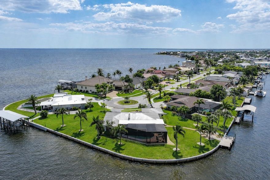 261 FEET OF SEAWALL ON CHARLOTTE HARBOR WITH JUST 1 MINUTE TO OPEN WATER—THIS IS TRUE SAILBOAT ACCESS AT ITS FINEST. Situated on an expansive HALF-ACRE LOT AT THE END OF A QUIET CUL-DE-SAC, this rare waterfront property delivers unmatched privacy, panoramic views, and the ultimate Florida boating lifestyle.

Welcome to a home where every detail has been thoughtfully curated to maximize both comfort and the breathtaking surroundings. From the moment you arrive, the lush, professionally designed landscaping and freshly painted exterior set the tone for what awaits inside. Step through multiple glass doors and be instantly drawn to the shimmering water views that stretch across Charlotte Harbor—visible from the main living areas, the primary suite, and a spacious sunroom designed for year-round enjoyment.

The interior offers a bright, OPEN-CONCEPT layout enhanced by tile flooring throughout the main living spaces, with cozy carpeting reserved for the bedrooms. The CUSTOM KITCHEN, COMPLETELY UPDATED IN 2021, is a true showpiece featuring CAMBRIA QUARTZ COUNTERTOPS, HIGH-END APPLIANCES, AND BUILT-IN CONVECTION OVEN AND MICROWAVE, creating a space that is as functional as it is beautiful.

Outdoor living is where this property truly shines. An OVERSIZED HEATED SALTWATER POOL is perfectly positioned to take full advantage of the sweeping harbor views, all enclosed within a FULL-LENGTH PICTURE FRAME SCREENED CAGE that keeps your sightlines completely unobstructed. The EXPANSIVE SCREENED LANAI offers multiple areas for relaxing or entertaining, seamlessly blending indoor and outdoor living.

Boating enthusiasts will appreciate the NEWLY INSTALLED 28x10 CONCRETE DOCK (2024) along with the impressive 261 FEET OF WATER FRONTAGE, providing ample space for multiple vessels and effortless access to Charlotte Harbor and beyond—NO BRIDGES, NO WAITING, just straight out to open water.

Additional highlights include a BRAND NEW STANDING SEAM METAL ROOF (2024), HURRICANE FILM inside of ALL windows, meticulously maintained systems, and a layout designed to capture natural light and water views from nearly every angle.

Located just minutes from downtown Punta Gorda, you’ll enjoy quick access to waterfront dining, boutique shopping, parks, and live entertainment—while still enjoying the peace and exclusivity of this tucked-away harbor front setting.

PROPERTIES LIKE THIS—WITH THIS MUCH FRONTAGE, THIS KIND OF ACCESS, AND THIS SIZE LOT—ARE EXTREMELY RARE. DON’T MISS YOUR CHANCE TO OWN A TRUE WATERFRONT SHOWPIECE.