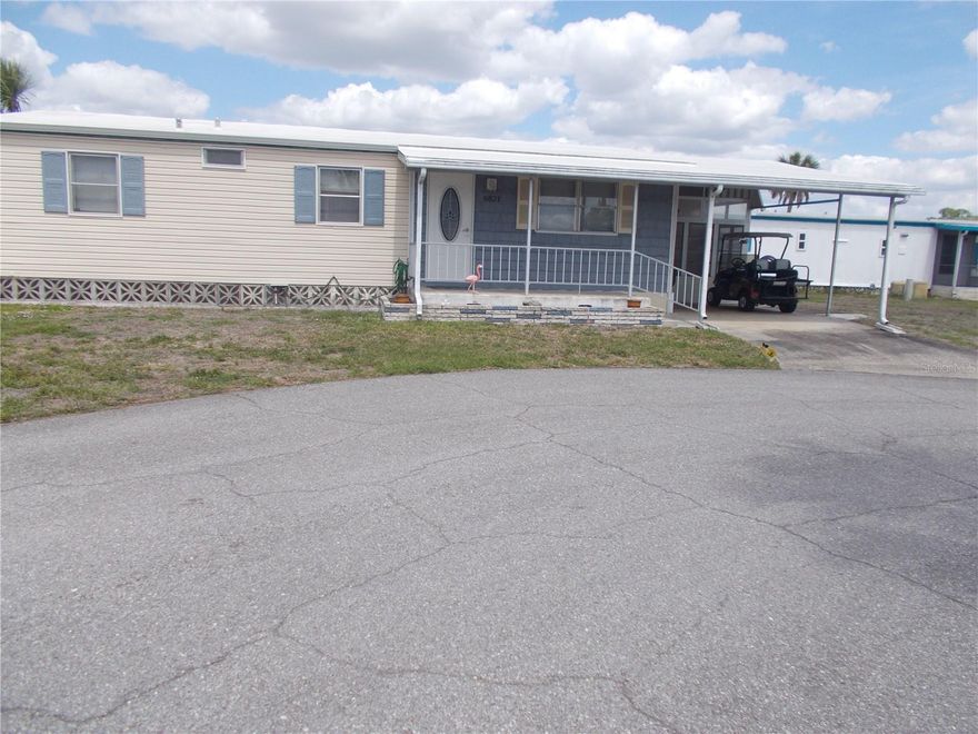 This is a 3-bedroom, 2 bath Doublewide home in the gated mobile home community of Holiday Park and in the PET SECTION. As per the seller the roof and carport were replaced in 2022,2023 and new gutters in 2022. Vapor barrier and Hot Water Heater in 2021, AC 2020.  Main electric box 2022, Lanai 2018 and new water main in 2016. You have a lanai, a 7X8 shed and a lovely porch off of the living room where you can sit and relax. In Holiday Park you own the land with a deed and your $195.00 monthly maintenance fee ($2340.00 a year) is included in your taxes. The community features 2 clubhouses, 2 swimming pools, a library, a fitness room, tennis courts, pickleball & bocce courts, to name a few. You are close to shopping, dining, entertainment, numerous golf courses, sports facilities, and SW Florida's renowned beaches. Come take a look!