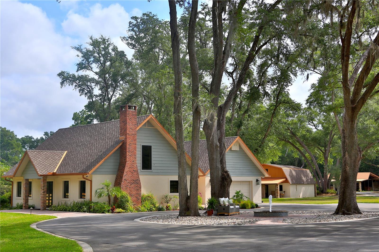 Direct access to the Greenways, you’ll enjoy paved bike paths, mountain biking trails, and miles of picturesque horse-riding trails right at your doorstep. This stunning property sits on an expansive 6.89+/—acres. It is a unique opportunity for horse enthusiasts and outdoor lovers alike, featuring a main residence, a guest residence, and a five-stall horse barn with an apartment. This impressive two-story residence boasts 2 bedrooms and 2.5 bathrooms, along with a spacious 2-car garage. The highlights include a brand-new Presidential Triple Laminate Shingle roof, elegant copper gutters, and a full-house Generac propane generator for peace of mind. Enjoy modern living with new stainless-steel appliances, custom solid wood cabinets, and beautiful granite countertops throughout. The luxurious owner's suite features a stunning back wall made of a single granite slab, and the entire home showcases heated tile floors, opting for tongue-and-groove walls instead of drywall. Cozy up by the Chicago brick gas fireplace or unwind on the expansive back paver deck. Additional features include a water softener, a dedicated laundry room, and a convenient garage door opener. Perfect for guests or Airbnb rental potential, this charming residence includes two bedrooms and three bathrooms, each with its own private entrance or the option to connect. The property features a full kitchen downstairs and a kitchenette upstairs, both adorned with granite finishes. Enjoy the benefits of new mini-split units, a full gym/workout room (which can be easily converted into a third bedroom), and a separate laundry room. Relax on either the front or rear covered porches. The well-appointed barn features five stalls, a feed room, a tack room, and two wash racks equipped with hot water. A cozy sitting area makes it a perfect gathering spot after a day of riding. Barn Apartment: This private one-bedroom, one-bathroom apartment features a kitchenette and a mini-split A/C unit, ideal for added privacy or accommodating guests. This fully fenced and cross-fenced property features five paddocks equipped with concrete waterers. An inviting asphalt driveway with concrete curbing leads to the custom solid aluminum gate. Enjoy evenings by the fire pit, appreciate the serene lighted fountain, and revel in the plentiful outdoor lighting that enhances this beautiful estate. Rare opportunity to own a remarkable property that truly has it all!