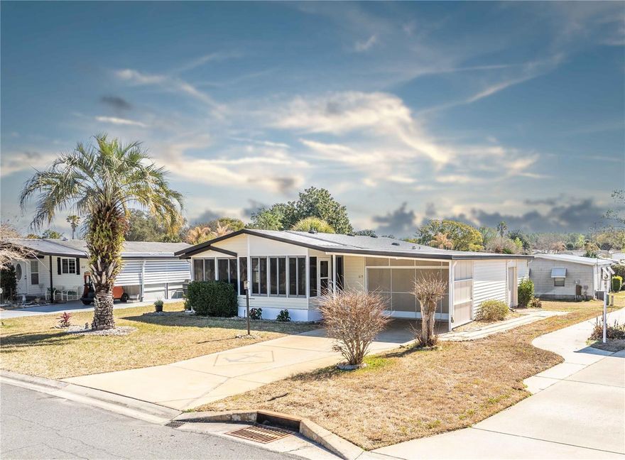 Tucked away in the village of Orange Blossom Gardens, this beautifully remodeled two bedroom, two bathroom home is offered fully furnished and move-in ready. Major updates include a new roof, HVAC system, water heater, and appliances, and the home also includes a washer and dryer for added convenience.

Inside, you'll find a bright open floor plan that flows into a spacious kitchen, creating an ideal layout for entertaining. The front lanai has been enclosed under heat and air, adding approximately 300 square feet of additional living space, perfect for a sitting area, office, or hobby room.

Conveniently located near the guarded entrance, the home offers quick access to grocery stores and nearby shopping centers. Directly across the street, the newly remodeled Del Webb adults-only pool provides a relaxing retreat just steps from your front door.