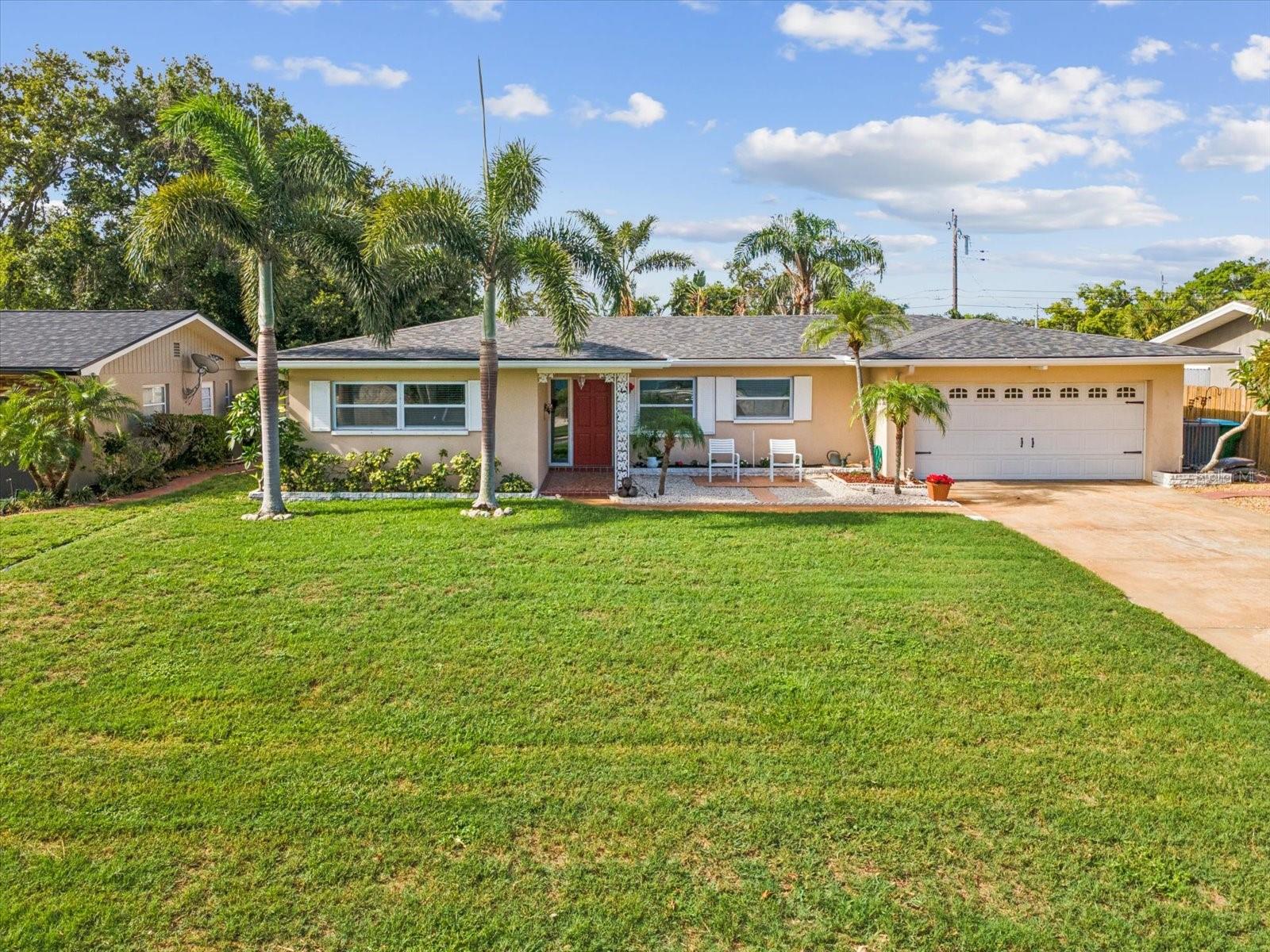 Welcome to this beautifully maintained 3-bedroom, 2-bathroom pool home located in the highly desirable Harbor Hills neighborhood—outside of the flood zone and zoned for top-rated Anona Elementary. This charming residence features a brand new roof and newer AC, offering peace of mind and comfort year-round. Step inside to discover a perfect blend of original natural charm in exceptional condition and thoughtful modern updates, including an updated kitchen with breakfast nook, custom cabinetry complimented by beautiful granite countertops and a pass-through bar with additional seating. The split floorplan offers a generous dining space and living room along with an expansive Florida room which makes a good second living room/flex space large enough for an office and playroom. The spacious primary suite has natural parquet floors a walk-in closet and is finished with a gorgeous en-suite. Enjoy true Florida living in your tropical backyard oasis—complete with a sparkling pool and custom deck perfect for entertaining. Other upgrades include a new pool pump, new paint and new vinyl flooring. The home boasts excellent curb appeal and is nestled in a golf cart-friendly community just minutes from shops, dining, and some of America’s best beaches. Don’t miss this rare opportunity to own a piece of paradise in one of the area’s most sought-after neighborhoods!