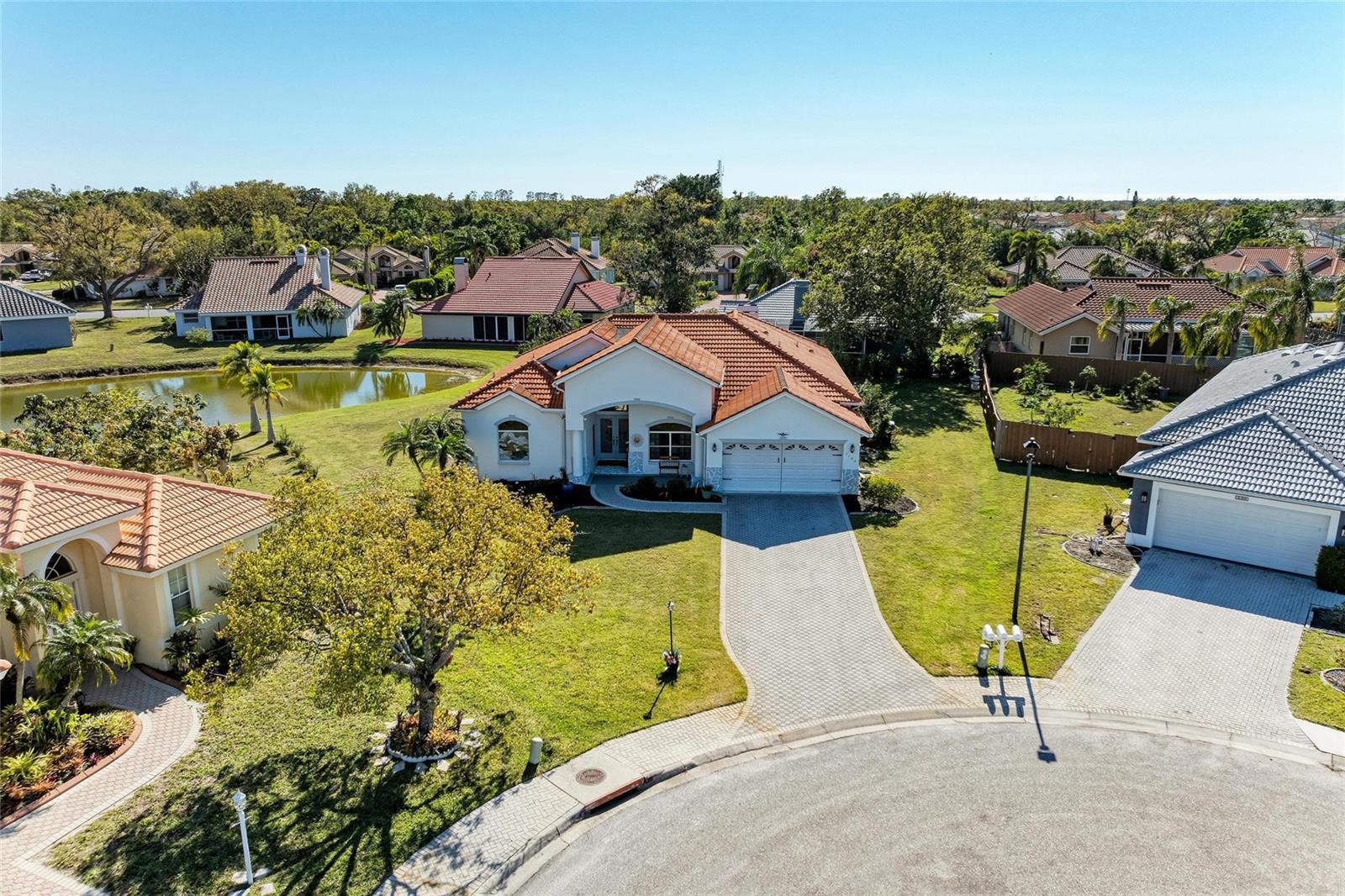 Welcome to The Trails in Sarasota! This beautiful 3 bedroom/2 bath split floor plan home has tasteful curb appeal, many recent upgrades, a wood burning fireplace, and rests on a third of an acre. This spacious 2100 sq ft home has high ceilings, plenty of natural light throughout, and has recently installed luxury plank vinyl flooring. The kitchen has ample cabinet space, a pantry, newer backsplash, stainless steel appliances, durable granite countertops, and a breakfast bar. The living room has sliding doors to the lanai, and connects to the dining room near the kitchen. The family room also has slider to the lanai, with the corner fireplace and beautiful lake views. The Primary suite has french doors to the lanai, plenty of closet space, his/her sinks and a walk-in shower. The additional two bedrooms are perfect for family, office or guests. The lanai has spectacular views of the lake, covered area for those rainy days, is perfect for entertaining, and was re-screened in 2024. Other upgrades to this home include primary bath renovation, kitchen, and new AC in 2024! This gorgeous home in a sought after community has low HOA fees, no CDD fees, and has lower taxes than Sarasota county. All of this conveniently located near shopping, restaurants, SRQ Airport, downtown Sarasota, UTC Mall, and the world famous beaches of Florida's Gulf Coast!!