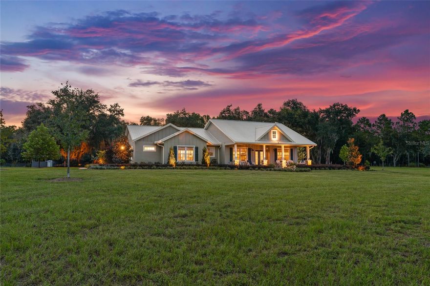 Wind down the gated entrance lined with stately columns and arrive at a property where comfort, charm, and thoughtful details await in this gorgeous 3 bedroom 2 1/2 baths. Surrounded by the natural vinyl fencing, the grounds are beautifully maintained with lush landscaping and up lighting that creates a warm, welcoming glow. From the wide front porch, you can relax on a swing or rocking chair while taking in long-range views of the pasture and watching the deer and turkey that often wander by at dusk. Inside, the kitchen is designed for both everyday living and entertaining. A spacious island offers the perfect gathering spot, while the walk-in pantry keeps everything organized and within reach. The living area is anchored by a cozy gas fireplace, creating an inviting atmosphere year-round. Enjoy the flex/bonus or use it as an additional bedroom if needed.  Outdoors, the home is equally suited for entertaining and unwinding. A pavilion with a wood-burning fire pit (plus electric and water access) sets the stage for cozy evenings, while the 15x15 gas fire pit invites gatherings under the stars. Multiple custom-built sheds, a 20x30 Carolina carport, and pole barns with electric, fans, and rock columns blend style with function. And for the ultimate hosting experience, a 30x60 structure with electric, water, septic, an outdoor kitchen, and soaring 14' eaves is ready for your largest celebrations. As a bonus, the property also includes a 2023 36' park model home— perfect as a guest house, in-law suite, or private retreat.