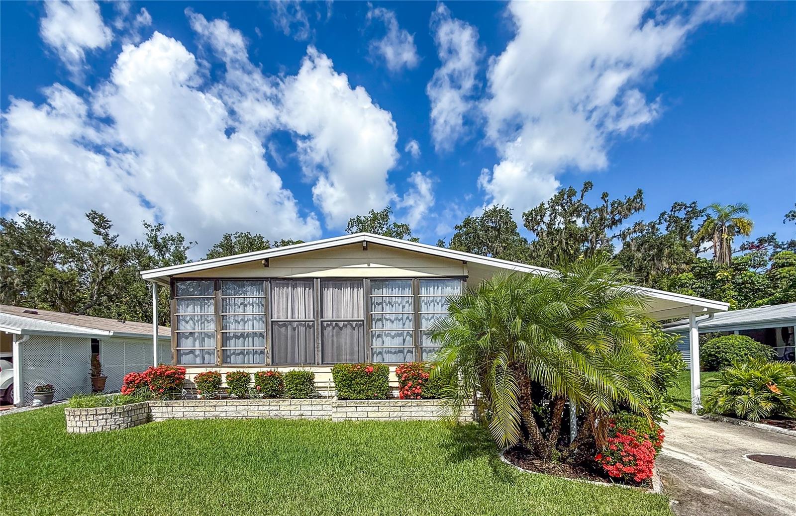 Beautiful, 2bd/2ba home located on a spacious lot in the 55+, land owned community of Ridgewood Oaks. Extra-large carport with room for 2+ cars and a golf cart. Oversized workshop, with an additional storage shed provides for plenty of storage/workspace. A new roof and all new windows have been added this past year. A well designed, furnished, open floorplan home with beautiful laminate flooring throughout, indoor washer/dryer and lots of cabinets for storage. Newer appliances. cabinets and counter tops in the kitchen/with a breakfast bar. Living room is open with lots of widows which leads out to the spacious front lanai. Large 2nd bedroom and the bonus room could be a 3rd bedroom, office or craft room. The master bedroom has a walk-in closet and plenty of room for a king bed. If you like nature, this is the home for you as it has a HUGE 10’ x 20’ screen porch right off your master bedroom where you can relax in private and enjoy your morning coffee. This is a very well kept home with too many features to list. Internet & cable, lawn maintenance & sprinkler system are included with your low quarterly condo & HOA fees. The Ridgewood community features a beautiful clubhouse, pool, spa, tennis courts, pickle ball courts, shuffleboard and an outdoor fitness area. This community is also golf cart and small pet friendly. Ridgewood location has close access to I-75, many restaurants, the Ellenton Outlet Mall, the Manatee County Library and provides 24-hour gated security. Land owned with lots of planned community activities. All room sizes are approximate. All information is deemed reliable but should be verified by buyers and/or buyer's agent.