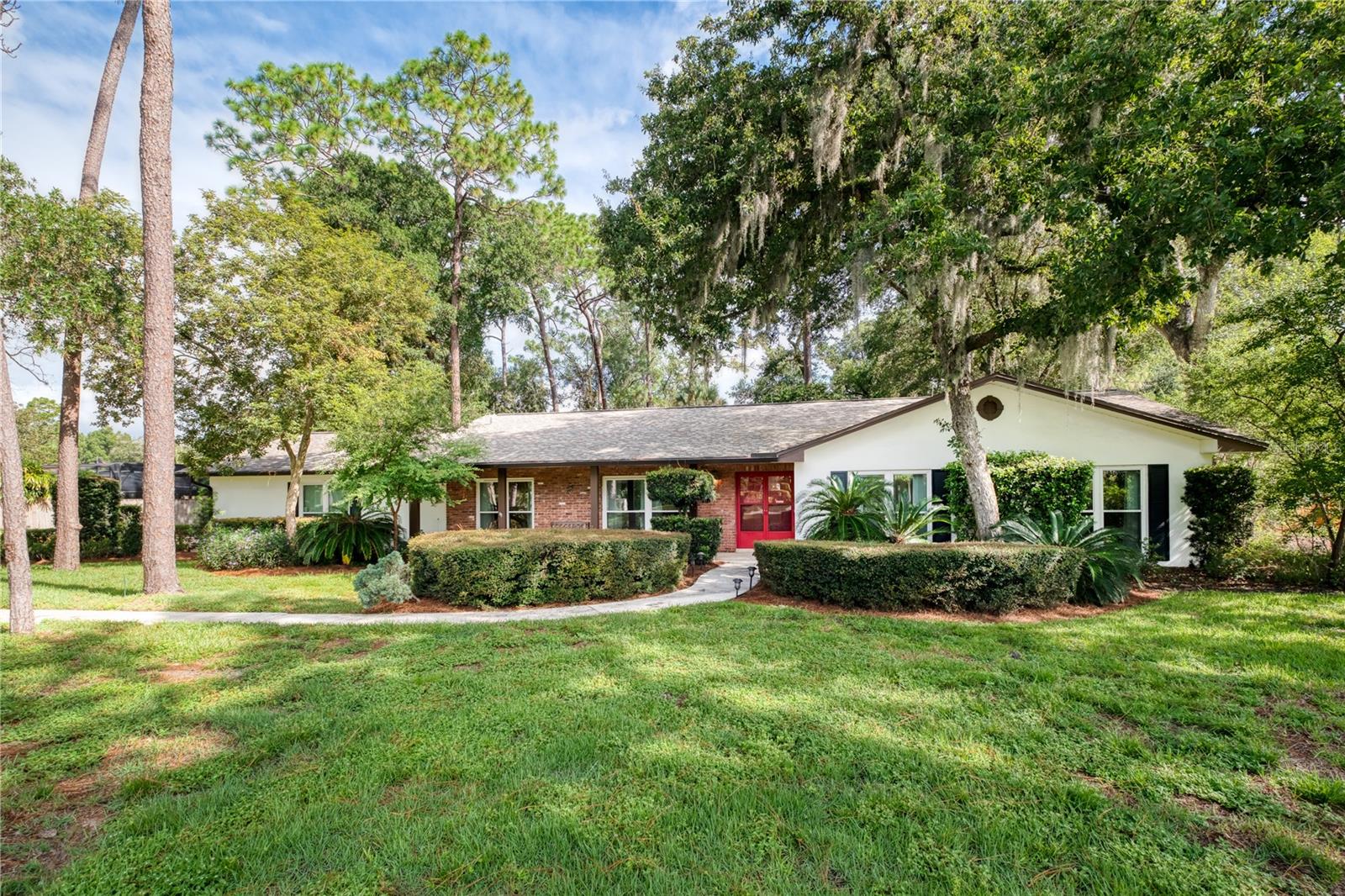 Welcome to your own private retreat in the heart of Longwood! Situated on a lush and expansive .69-acre lot, this beautiful single-family home combines thoughtful upgrades with natural beauty, offering the perfect blend of indoor comfort and outdoor living. Major updates include, Roof (2019), HVAC (2022), Windows + Doors (2021), Repiped (2019) and more. Step inside to find a sprawling floor plan with two spacious living rooms, a formal dining area and an open concept kitchen overlooking the beautiful pool area. The oversized owners suite has ample natural light, both duel closets and a walk-in closet and a fully updated ensuite bathroom with gorgeous finishes. Each bedroom is generously sized, offering plenty of room for rest and relaxation. The flexible layout also includes a bonus bedroom with a separate entrance off the pool area and garage, ideal for a 4th bedroom, home office, in-law suite, guest quarters, or creative studio. Outdoors, enjoy your own personal paradise with a sparkling pool, a covered screened in patio, a huge backyard filled with blooming azaleas, stunning greenery, and plenty of space to entertain, garden, or simply unwind! This home also features a 2.5 car garage, perfect for 2 cars and a golf cart, bikes and/or extra storage space. Don’t miss this rare Longwood gem—schedule your showing today!