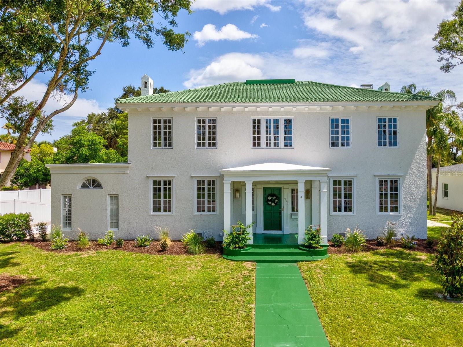 Welcome to this quintessential Belleair estate, a masterful blend of timeless elegance and modern refinement. Thoughtfully restored with exquisite attention to detail, this historic residence sits on a picturesque, palm tree-lined street. Take advantage of the Belleair lifestyle in your personal golf cart and explore all that the community has to offer including world class golf at Belleair Country Club and The Pelican Golf Club, fine dining, shopping and some of America’s most beautiful beaches. Located in a non-flood, no evacuation zone, the estate offers sweeping golf course views, a resort-sized pool, and a spacious driveway with ample room for vehicles. Inside, you are welcomed by custom marble flooring that flows into a grand formal dining room, ideal for family gatherings. An aesthetically pleasing, professionally designed chef’s kitchen awaits just beyond, complete with a butler’s pantry and adjacent powder room. The first-floor primary suite is a true retreat, featuring refinished 20th-century hardwood floors, a pass-through fireplace, a luxurious en-suite with soaking tub, and a walk-in closet with handcrafted wood shelving. Throughout the home, restored original windows provide an abundance of natural light and frame views of century-old palms and manicured fairways. Two versatile flex spaces—one on each floor—offer options for a home office, nursery, or playroom. Upstairs, four spacious bedrooms each have dedicated bathroom access for convenience. Down a private hallway, a game/media room with half bath provides the perfect secluded entertainment space. Additional highlights include a 400 sq ft living room with wood-burning fireplace and a bright sunroom overlooking the expansive pool and sun deck—an entertainer’s dream. This exceptional property combines history, luxury, and location, offering the rare opportunity to call one of Belleair’s true legacy's home.