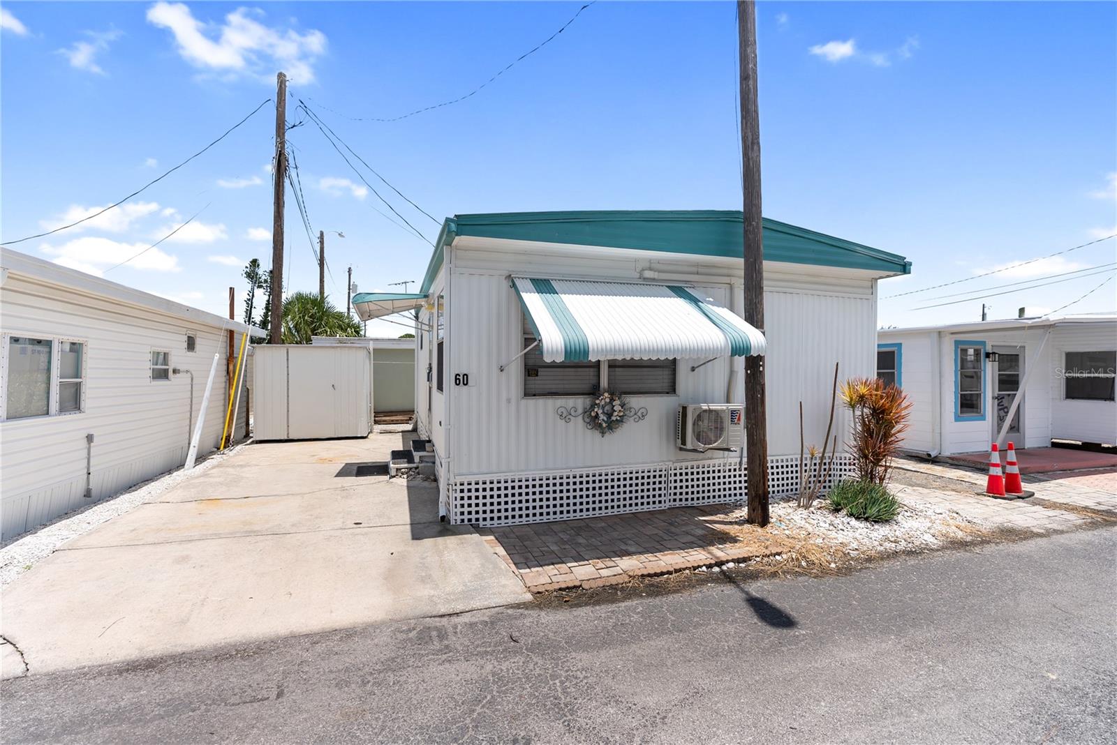 Welcome to your slice of paradise in the highly sought-after 55+ community of Paradise Bay Estates! Offered completely turnkey and move-in ready, this home is designed for comfort and ease. This delightful 1BR/1BA home features a cozy living area and kitchen with a dining area too. One shed even includes a washer. The main bedroom currently features a queen bed. Plus, a brand-new split system heat/AC was installed in December 2024 after the home received a refreshing update post-hurricanes Helene & Milton. Paradise Bay Estates is an active and vibrant community with fantastic amenities, including a heated pool and spa, pickleball courts, shuffleboard, a boat ramp, and available boat dockage (waitlist applies). There’s always something happening—from potlucks and musical shows to golf outings, community lunches, and music by the bay. Nestled along the picturesque shores of Sarasota Bay, residents enjoy stunning wildlife, charming gazebos, and breathtaking sunsets over Anna Maria Island and Longboat Key. Don’t miss this opportunity to enjoy the Florida lifestyle in a premier waterfront community!