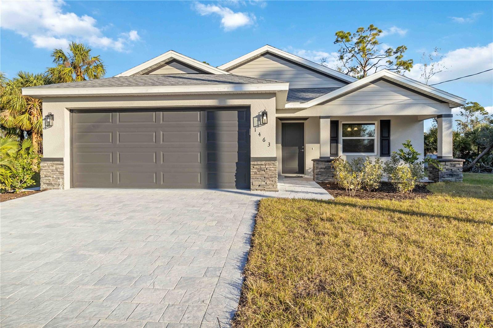 Ask about a rate buydown credit from the seller! Welcome to this stunning, move-in ready new construction home in the desirable city of North Port, Sarasota County. Built by a trusted local builder, this home offers all the benefits of a custom build without the long wait times. Featuring 3 spacious bedrooms, 2 beautifully designed bathrooms, and a 2-car garage, this property is perfect for those seeking comfort and convenience. The home sits on an oversized lot and is not in a flood zone, providing peace of mind and plenty of outdoor space. The stone accents and paver driveway create incredible curb appeal, while the front porch with a paver seating area is ideal for enjoying Florida’s sunny days. The screened-in lanai at the back provides a perfect retreat for relaxing outdoors. Inside, you'll find upgraded wood cabinets with soft-close drawers, an overmount rectangle sink, and high-end stainless steel appliances in the kitchen, along with a pantry and tile backsplash. The home is finished with luxury vinyl plank flooring throughout, and the bathrooms feature stylish tile floors with a tiled shower and glass door in the primary bath. The large walk-in closet in the master suite offers ample storage space, and all fixtures have been upgraded to provide a modern, polished feel. Additionally, the home is equipped with energy-efficient windows, helping to keep utility costs low. As a bonus, the builder includes a 2-year warranty and a 10-year structural warranty, offering added peace of mind. This beautiful home is ready for immediate occupancy, so don’t miss out on the opportunity to make it yours!