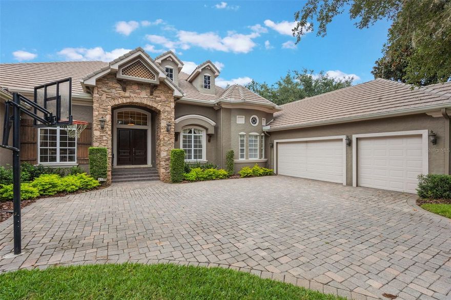 This elegant single-story Rick Watson home, located at 6102 S Hampshire Court, Windermere, FL 34786, sits on a private Jack Nicklaus–designed golf course lot in the exclusive, 24-hour manned and gated community of Keene’s Pointe. Enjoy uninterrupted views of the 6th hole by day and Disney Fireworks at night from key living areas and the outdoor lanai. The home features 4 bedrooms, 5 bathrooms, a custom office, and a bonus room, anchored by a luxurious master suite with a sitting alcove, walk-in closet, and spa-like bath. The gourmet kitchen offers professional appliances, granite counters, an “invisible” walk-in pantry, and breakfast bar, while the custom office showcases fine woodwork and built-ins. Outside, a private resort-style heated pool and spa, summer kitchen, pavered lanai, and a state-of-the-art automatic mosquito misting system make outdoor entertaining effortless. The exterior is finished in stucco and stacked stone, with a 3-car side-entry garage and paver driveway. Ideally located in one of Central Florida’s most sought-after areas, the home provides access to top-rated schools, nearby hospitals, premier shopping centers, and is just a short drive to Walt Disney World and other major attractions, combining luxury, convenience, and lifestyle in one exceptional residence.
