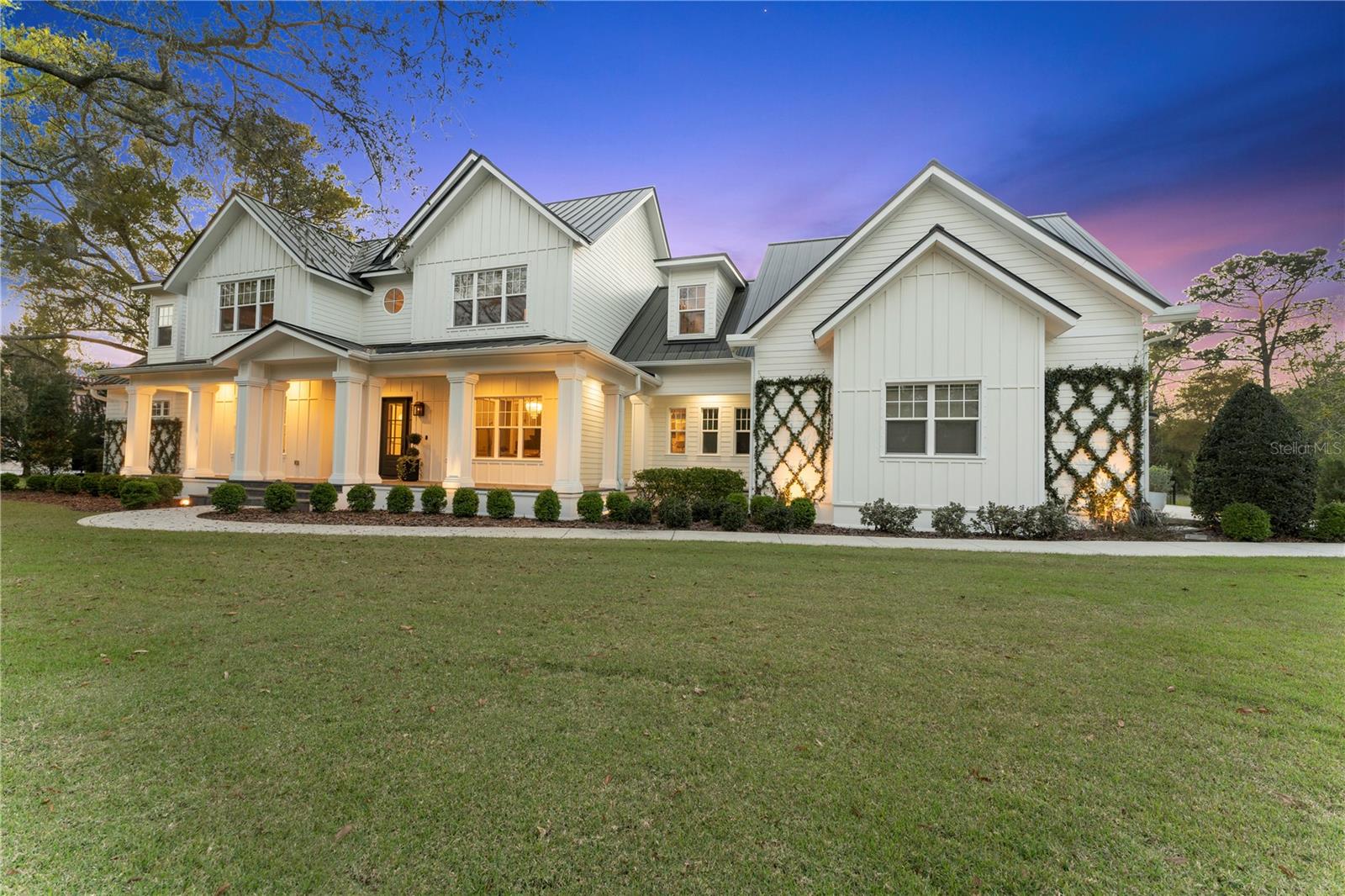 Welcome to the epitome of luxury living. Nestled within the highly sought-after Odessa neighborhood of Stillwater, this home offers the ultimate in opulence and exclusivity. As you approach the property, you'll be greeted by the charm of gas lanterns adorning the southern-style front porch, a tantalizing preview of the elegance that awaits you inside. Prepare to be captivated by the exquisite craftsmanship and attention to detail that envelop this residence. Upon entering, you'll be greeted by custom woodwork that spans throughout the home, showcasing the impeccable artistry and quality. To your left, a well-appointed home office awaits, complete with a closet for added convenience. From this vantage point, you can enjoy the serene view of the magnificent Grand Oak tree gracing the front yard, creating a serene ambiance. Continue further and you will discover your very own private bar, a sanctuary where you can unwind and relax after a long day. This thoughtfully designed space features glass and metal doors, seamlessly merging elegance with functionality. Adjacent to the bar, you'll find the elegant dining room adorned with coffered ceilings, providing a touch of grandeur. This space flows effortlessly into the large walk-in pantry and coffee bar, catering to your every culinary desire. The heart of this home is a chef's dream come true. The expansive eat-in kitchen is equipped with top-of-the-line Viking appliances and offers ample storage space. Whether you find joy in preparing elaborate meals or simply appreciate the art of cooking, this kitchen will exceed your expectations. As you prepare delicious dishes, you can savor the beauty of your surroundings, with indoor and outdoor gas fireplaces creating a cozy ambiance in both the kitchen and the adjoining light-filled great room. Retreat to the main floor's primary bedroom, an oasis of calm and sophistication. Vaulted ceilings lend an air of elegance, while two walk-in closets, equipped with custom closet systems, offer ample storage for your wardrobe. The primary bathroom is a haven reminiscent of a five-star resort, featuring two vanities, a spacious shower with double shower heads, and a luxurious soaking tub, inviting you to indulge in a moment of relaxation and rejuvenation. Upstairs, you'll find three additional well-appointed bedrooms, accommodating both family and guests with comfort and style. Two additional bathrooms, a library, and an oversized bonus/game room provide ample space for a variety of activities, ensuring that every member of your household has room for relaxation and recreation. Step outside, and you'll discover an outdoor space designed for both relaxation and entertainment. The expansive screened-in and open porches provide the perfect setting for enjoying the beautiful surroundings in comfort and style. Take a dip in the heated saltwater pool or unwind in the inviting spa. The fenced-in backyard offers privacy and ample space for outdoor activities and enjoyment. No detail has been overlooked in this exceptional residence, which truly embodies the pinnacle of luxury living. Experience the height of sophistication and indulge in a lifestyle reserved for the discerning few.
