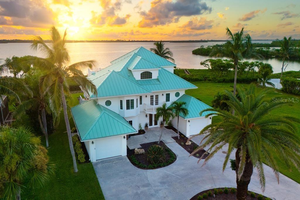 Eagle Preserve Estates | Waterfront Luxury on Lemon Bay- For those who cherish privacy yet enjoy a friendly, gated community tucked between Lemon Bay Golf Club and the Intracoastal Waterway (ICW), Eagle Preserve Estates is one of the area’s best-kept secrets. The views here will take your breath away—tranquil open water, gentle Gulf breezes, and nightly sunsets that turn the sky to orange and gold. Imagine enjoying all of it from your own home. This extraordinary bayfront residence delivers the best of the Florida lifestyle. Set amid a hidden community and neighboring the esteemed Lemon Bay Golf Club, the home offers unobstructed vistas of Lemon Bay and effortless water access. Inside, an open-concept main level invites seamless living and entertaining: a spacious great room flows to a well-equipped kitchen and dining area—each space oriented to the water. Wide telescoping glass doors open to an expansive covered lanai overlooking the pool, patio, and bay, creating an indoor-outdoor experience that’s pure coastal ease. Intentional design details elevate the home’s relaxed sophistication: a fireplace accented in soft coral tones, and a built-in wet bar with handcrafted backsplash made from reclaimed boat wood—a nod to the area’s maritime heritage. The primary suite is a serene retreat with dual walk-in closets, a spa bath with soaking tub + separate shower, a private wet bar, and direct access to a secluded outdoor lanai where swaying palms and the sounds of the bay set a peaceful tone. Outdoors, enjoy 105 feet of waterfront with a private dock—ideal for kayaks, jet skis, paddleboards, and fishing. Sip morning coffee as manatees, dolphins, and eagles make their rounds; unwind at sunset on your balcony as the day drifts away. High-value improvements include impact windows and doors, a standing-seam metal roof, updated landscaping, refinished pool, Newly Constructed Dock and Hardie Board siding with vented soffits—marrying style, durability, and peace of mind. All of this is privately tucked away yet just minutes to golf, beaches, world-class fishing, waterfront dining, and boutique shopping—including the soft sands of Boca Grande and Manasota Key. Call for your private showing. Experience the serenity, craftsmanship, and coastal lifestyle that make this Eagle Preserve Estates waterfront home truly exceptional.