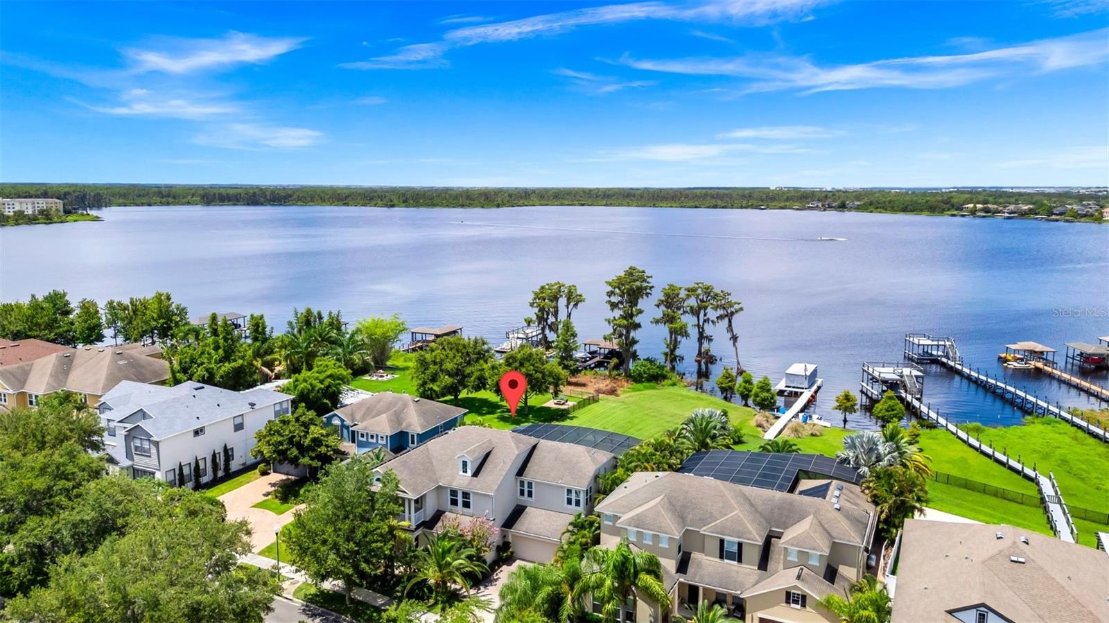 LAKEFRONT!!! Gorgeous 4 BR, 3.5 BA TWO STORY, POOL HOME on a wide LAKEFRONT lot on LAKE Speer in WINDERMERE. The home has unobstructed views to a natural shoreline across the lake. The travertine patio is plumbed and ready for an outdoor kitchen. As you enter the home, you are greeted with exquisite views of Lake Speer. The open floorplan makes living and entertaining a breeze. The master suite features stunning views of the lake. solar panels installed in 2019 that will render a normal electric bill at less than a 2 bedroom apartment . Working from home is easy in the large home office located off of the front entryway. The bonus room at first floor that can be utilized as 5th bedroom. The Screened Pool is just what you have wanted when you want to entertain and relax, Large Extended Covered Patio along with the pool make this a true oasis. Summerport in a modern Orlando Community features a clubhouse, community pool, fitness rooms, fishing dock, tennis, basketball courts, trails and more!! This home is close to Disney, downtown Winter Garden and downtown Orlando, Convenient to the 429, Winter garden Village Shopping and Dining . Enjoy all that Windermere has to offer - This home offers the best of the Florida Lifestyle.