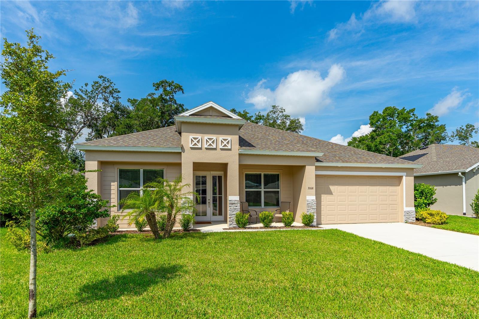 Atypically large, well-designed home, consisting of 2,618 sq. ft. of living area with a 3-car tandem garage. This home offers 4 rare non-stacked bedrooms and 3 full bathrooms. Built less than two years ago, it combines the feel of a brand-new home with thoughtful premium upgrades throughout. Located in the sought-after community of Halifax Plantation. Step inside through the impressive full-glass double front doors to find an airy foyer with an architectural ceiling and two sun-filled rooms leading into the spacious open-concept living, dining, and kitchen areas—perfect for entertaining or relaxing. The living room and primary bedroom feature elegant tray ceilings, while high-end lighting enhances the living, dining, and entry spaces. Plush carpet graces all four large bedrooms, each with its own ceiling fan for comfort. The luxurious and oversized primary suite includes a walk-in closet and a beautifully updated bathroom, complete with an oversized walk-in shower, frameless glass doors, deluxe floor tile and a specially constructed concrete base for improved drainage. Large windows throughout, including in the primary bath, invite natural light and showcase serene views.
Enjoy a private, quiet backyard surrounded by lush vegetation. Additional highlights include a perfect Florida east-west home orientation, and access to Halifax Plantation's resort-style amenities - golf, tennis, swimming, and an on-site restaurant.
With its exceptional size, thoughtful layout, and premium upgrades, this home delivers comfort, elegance, and space in one perfect package. This is more than a home, it's a lifestyle. Don't miss your chance to own one of Halifax Plantation's finest! Square footage received from tax rolls. All information recorded in the MLS intended to be accurate but cannot be guaranteed.