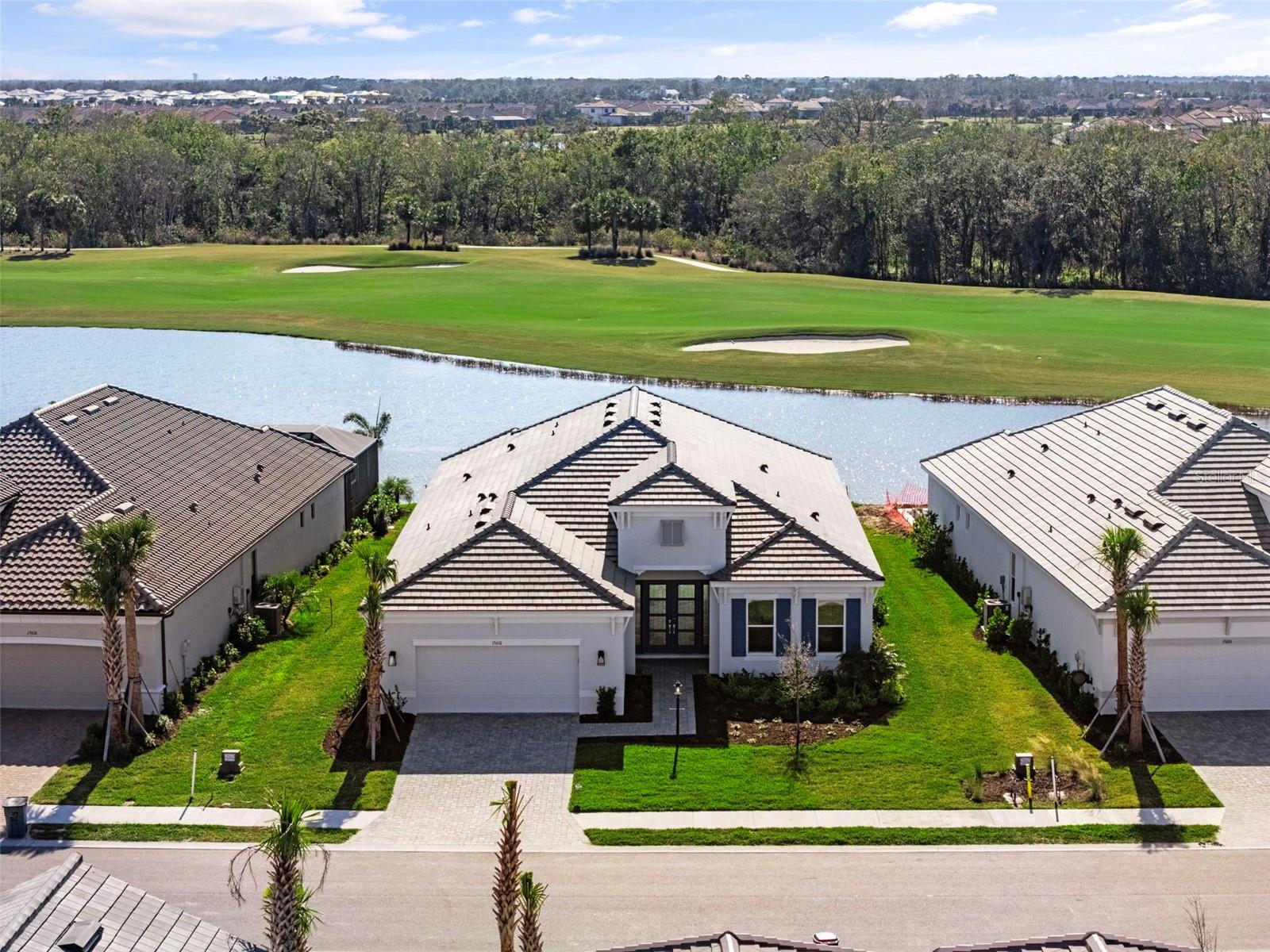 One or more photo(s) has been virtually staged. A truly one-of-a-kind golf-deeded property, this exceptional home is one of the few in the entire community that offers breathtaking, unobstructed views of the lake, golf course, and preserve—without a golf cart path nearby, ensuring ultimate privacy. Located at 15610 San Lazzaro Ave, Lakewood Ranch, FL 34211, This highly desirable Pallazio floor plan includes three bedrooms, three bathrooms, a versatile den, and a three-car tandem garage. Construction was finished in January 2025 (never has been lived in).
With 1,488 homes, including 850 golf-deeded properties, Azario transforms into a private golf course once the HOA is transferred. This lot is ideally located within walking distance to all amenities and the golf pro shop, making it the perfect spot for your new home!
Designed for both elegance and functionality, the home features upgraded tray ceilings, 8-foot doors, and a gourmet kitchen—perfect for those who love to entertain. Tile flooring throughout enhances the home’s modern aesthetic, while spacious walk-in closets in every bedroom provide ample storage. The property is pre-plumbed for an outdoor kitchen and wired for a TV, making outdoor gatherings effortless. Plus, with room to design your dream pool, the home is already pre-wired for a pool and hot tub. Impact windows throughout and a LiveSmart package ensure security and energy efficiency.
Set within the luxurious Azario at Esplanade, this community offers an unparalleled lifestyle with resort-style amenities. Golf enthusiasts will love the 18-hole championship golf course, full-service Pro Shop, Bunker Bar, and Aqua Driving Range. The clubhouse boasts a resort-style pool, Bahama Bar, and a full-service wellness center with a spa. Stay active with fitness classes, 16 pickleball courts, and 6 Har-Tru tennis courts, or indulge in gourmet dining at the Culinary Center. Social clubs, scenic walking trails, and a dedicated dog park complete the vibrant community experience.
With lawn maintenance, a full-time activities director, and access to world-class amenities included in an affordable monthly fee, this extraordinary home offers both luxury and convenience. Don’t miss this rare opportunity to own one of the best homes in Azario at Esplanade!