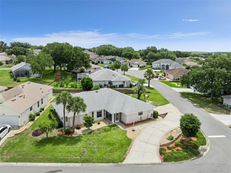 Welcome to low maintenance, open concept living!  This modified Princess Model CBS constructed home in the 55+ gated, golf community of Royal Highlands is located in central Florida’s Lake County!  Upon arrival you’ll appreciate the circular drive with ample visitor parking.  This updated home comes equipped with features including 42” upper kitchen cabinets, granite counters, pull-outs and pot drawers.  The interior has knockdown ceiling texture, custom walk-in closets, screened lanai with tiled flooring and sliding doors as well as an updated ceiling fan.  The master and guest bathrooms have dual vanities, and you’ll love the half bath located adjacent to the inside laundry room and garage.  Pick fresh lemons from your very own fruit tree!  Some furniture may be conveyed, please inquire! Vaulted ceilings, kitchen pantry, solar tube lighting, step-in shower, garage pegboards, and a utility sink for easy clean-up.  Over 2200 square feet of under air living, an oversized garage, 2021 roof, and this home is perched among the hills of Royal Highlands.  Our active, adult community has an on-campus restaurant, pro shop, driving range, 18 holes, a Great Hall for dancing and stage performances, as well as a Recreation Center with two pools, fitness center, billiards, library and craft space with kiln!  Additionally, the low monthly HOA fee includes cable and internet, softball field, pickleball & tennis courts, meeting rooms and trails. Call today for your home and community tour!