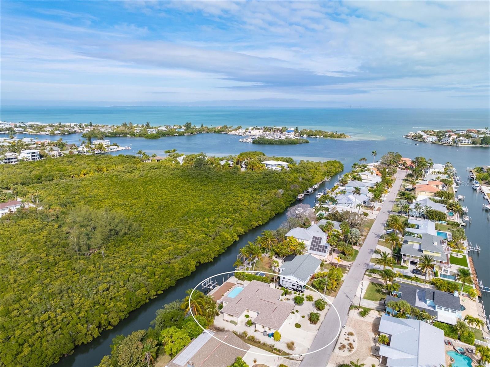 Located on arguably one of the best streets on Anna Maria Island, this single family home with 3 bedrooms plus a den and 3 bathrooms is one to look at. On the Westside you have a 3 block walk to the Gulf side beaches, to the East you can boat through Bimini Bay and directly out into the intercoastal waterways of Tampa Bay, and most notably you will enjoy a colorful sunset view over the mangroves from your back patio every night with no neighbors to stare back at you (something most homes on Anna Maria Island cannot say)!
This lovely waterfront home is located on a beautiful, boatable canal with no boat restrictions in the city of Holmes Beach. It is an ideal spot for beach lovers and boaters to enjoy as a vacation getaway or full time residence.
Upon entering this custom built home you will notice the 9.5 foot ceilings, crown molding, stone fireplace and lots of natural light. The master bedroom has an en suite bathroom with French doors from the bedroom leading out to a view of the pool and canal. Both of the additional bedrooms have their own full bathroom with ample closet space. The kitchen has custom cabinets, granite countertops and a large pantry. This home has a lovely den, that can be used as an office or playroom, a dining room, laundry room and large 2 car garage. This custom built home’s foundation is elevated 2 feet which allows for peace of mind for a ground level island home.
With over 90 feet of waterfront, one of the main features of this home is the backyard which has a lovely pool, a paved pool deck and a composite deck in addition to the wooden dock with a 13,000 pound boat lift. And most notably a private setting with tropical vegetation and the unique absence of houses across the canal to enjoy nightly sunsets!
This home is an islander’s dream come true, walks to the beach, boatable canal access to the bay and nightly sunsets from your backyard which speak for themselves.
Come take a look at this picturesque beach home and start living your island lifestyle!