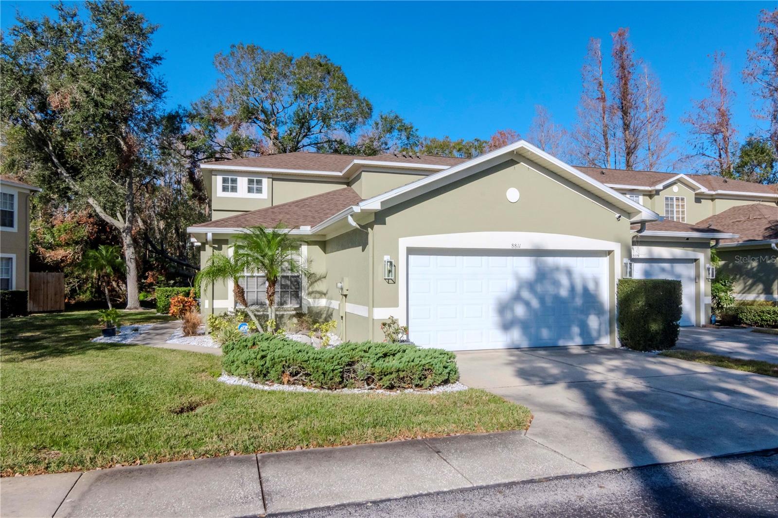 Discover the charm of this spacious end unit townhome in the tranquil community of Casa Blanca, nestled between Westchase and Citrus Park. This 3 Bedroom, 2.5 Bath townhome features a freshly painted interior and a great open floor plan with vaulted ceilings and hardwood floors throughout the living areas. The sleek eat in kitchen boasts 42" wood cabinets, granite countertops, a center island, stainless-steel appliances and stainless steel range hood. Sliding doors off of the family room open to a relaxing outside space with a wood deck and a conservation view. The primary bedroom is located on the first floor and includes a large walk-in closet, en-suite bathroom with a dual sink vanity and a vast walk-in shower. The second floor has two oversized bedrooms, a full bathroom and a loft space at the top of the stairs that would make the perfect reading nook. The large 2 car garage is equipped with electric vehicle charger and built in cabinets and shelving. The rent includes water, sewer, trash and lawn maintenance. This property is conveniently located close to the Veterans Expressway, Tampa International Airport, and an abundance of shopping, and dining!