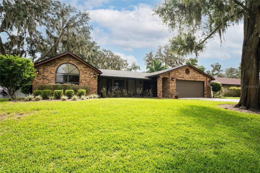 One of the most warm and charming homes in the Orlando area! Located in the highly desired Lake McCoy Forest community, this beautifully updated home offers peaceful Sunset Views over Lake McCoy from the Brand-New Screened Front Porch with brick pavers, ceiling fan, and SunTech screen door. Inside features Italian Travertine tile, a cozy Wood-Burning Fireplace, and Custom All-Wood Kitchen Cabinets with Soft-close drawers, Stainless Appliances, Brand-New Induction Range, and New Disposal and Faucet. Enjoy two Updated Baths, New Blinds, lighting, Ring doorbell, newer roof & AC, and a Smart Thermostat. Home is Replumbed with new Attic Insulation and Fan. The primary suite includes a sitting area and Lake Views. Outside, relax on the large screened patio overlooking your own slice of paradise, a fenced yard with lush Zoysia sod, avocado & mango trees. Plus, a garage workbench, shelving, and brand-new water treatment & softener system! This home is move in ready and a must see! Call today for your private showing.