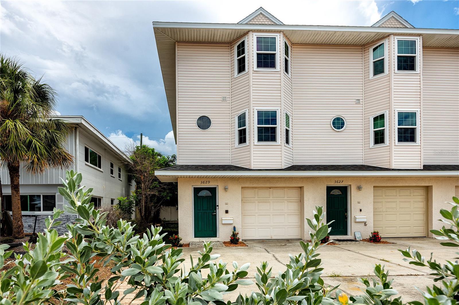This end-unit townhome in the sought-after Don CeSar District of St. Pete Beach combines everyday comfort with rare flexibility. Offering 2 bedrooms, 2.5 baths, and a tandem 2-car garage across three levels, the home is designed for both full-time coastal living and seasonal stays. With 30-day minimum rentals allowed, low monthly fees, and no approval required, it’s also a strong option for those seeking investment potential.
A private elevator connects each floor, leading to a gourmet kitchen with solid maple cabinetry, granite countertops, SubZero refrigerator, and a 2023 LG ThinQ gas range with griddle. A movable island with stools adds versatility, while the adjoining living area features oak flooring, a gas fireplace, and French doors opening to a balcony overlooking the private fenced courtyard.
The primary suite offers dual custom closets and a marble bath with soaking tub, walk-in shower, and dual vanities. The guest suite includes Gulf and Don CeSar views, a large custom-finished closet, and a private bath. Additional features include a laundry space with front-load washer and gas dryer, electric blinds on timers, abundant natural light, and a finished garage with Tesla charger, tiled floors, and extra storage.
Recent updates include impact windows (2023), new water heater (2024), newer HVAC and ductwork, and roof replacement in 2018. Residents enjoy private beach access just steps away, proximity to the Don CeSar resort, and quick connections to downtown St. Petersburg via the Pinellas Bayway.
Whether as a primary residence or a flexible beachside retreat, this St. Pete Beach townhome offers low-maintenance living, modern upgrades, and one of the most desirable locations on the Gulf Coast.