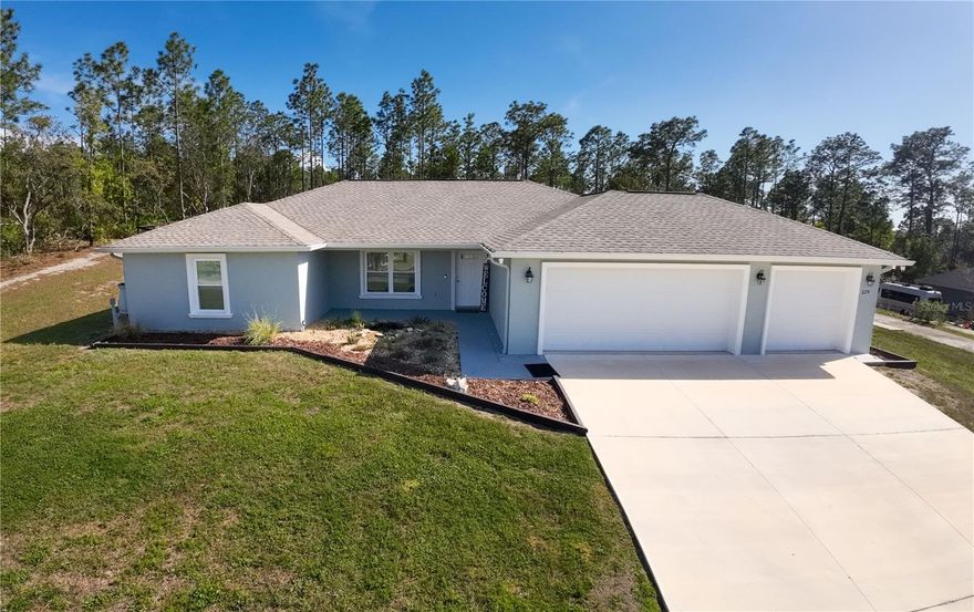 One or more photo(s) has been virtually staged. Located in the desirable Pine Ridge Estates equestrian community in Citrus County, this well-maintained 2023-built 4-bedroom, 2-bath home with 1,823 sq. ft. of living space and a 3-car garage sits on a spacious 1.01-acre lot at 6374 W Rio Grande Dr, Beverly Hills, FL 34465.  This property backs up to one of the community's many scenic horse trails, offering convenient access to the extensive equestrian trail system in Pine Ridge Estates. Enjoy the extended patio with sidewalk leading to the garage and featuring a barbeque/cooking area. The fenced yard includes two gates for easy access.  Designated RV parking with a 50 amp elextric service for RV Hookup.  For the gardening enthusist there are garden beds, and two rain barrels.  An approx 15x15 crushed concrete pad is ready for a future shed. Additional exterior features include gutters, an irrigation system, and termite protection in place.  Inside, the kitchen features a touch-free faucet and beautiful granite countertops in the kitchen and bathrooms, while the primary bedroom walk in closet offers convenient motion-activated lighting.  Lots of lighting in the 3 car garage.  This newer construction home provides practical outdoor space ideal for hobbies, gardening, or enjoying the peaceful equestrian setting of Pine Ridge Estates.