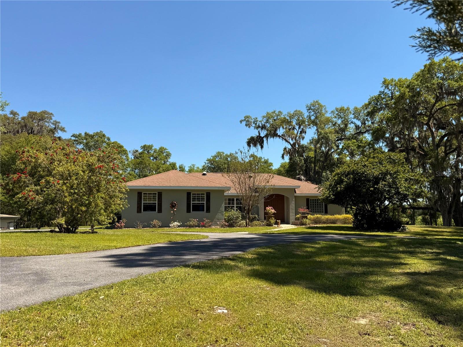 This home should be on HGTV! Looking for a Turn Key, CLEAN, Updated home on acreage? No deferred maintenance here. This Pool Home has been Tastefully Remodeled and shows pride of ownership. Take your shoes off and come in to see the Modern Rustic Charm this home has to offer. 3 Bedroom Split Plan, 2 Baths. High Ceilings, Open Floor Plan with a Gorgeous Chefs Kitchen that is perfect for entertaining. Chefs will love the 6 burner Gas Range ( 250 gallon buried Gas tank services the range, fireplace and Pool Heater) and Large Island with plenty of seating. Solar Tubes allow Natural lighting in the Kitchen and Living Room. The Spacious Primary suite has pool access, a Custom Walk In Closet and the ensuite is simply Stunning. Swim all year long in the Salt, Heated / Screened in Pool. Then Hop over to the Private Jacuzzi Cottage with air conditioning, Fan and a covered Front porch overlooking the Preserve. This Gated / Fully Fenced property is one of a kind. It sits elevated overlooking a Preserve that will never be built on. It is zoned A1 ( agriculture). Located in an Equine Community just 5 miles for the World Equestrian Center. Its typical to see Equestrians, Bicycle Riders and Walkers daily. The Home Owners Association is Voluntary. There is a small park and if you choose to join the fee is $95.00 annually.This property is cost friendly considering it is on a Well (no water Bill) and Septic , SECO is a Co-op Electric company (known for the lowest rates with cash back) High Speed Internet and low Property Taxes. Totally Turn key, Furniture is negotiable. If you are looking for a Homestead OR a property to rent out as an AirBnB this is absolutely PERFECT. No restrictions on leasing. Upgrades include KITCHEN / BATH renovations, ROOF 4/2025, HVAC 10/22, newer Appliances including washer and dryer that convey with sale , Water Heater, Well Pump, Water softener, Iron Filter tank, Pool Pump, Propane gas tank refurbished, Septic inspected and pumped 2025, Pool Deck painted 2025. The list goes on and on. Join us for an Open House August 30th between 11-2pm.