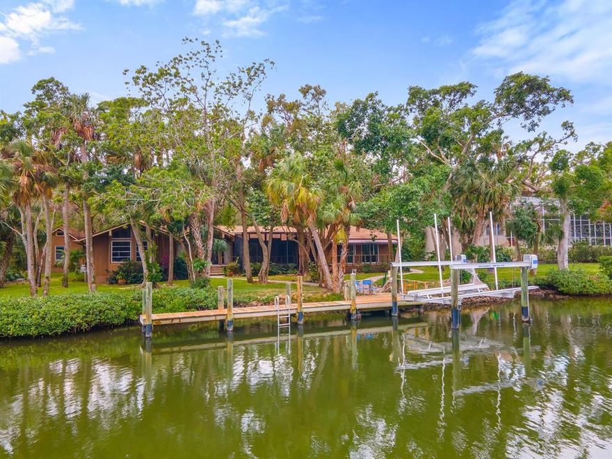 Sailboat water on Siesta Key with direct access to the intercoastal waterway. This is a rare property in Hidden Harbor on a canal with a boat dock on protected water. The circular drive brings to an old Florida ranch with charm and a small guest cottage too. The main house is a split plan with four bedrooms and three bathrooms, formal dining room, den, screened lanai overlooking the canal. All of the bedrooms have a water view too. The lot is enchanting with mature vegetation and mangroves along the canal side in a park like setting. Let's not forget the guest cottage with a full bathroom and the additional carport. This is a unique house with beautiful wood floors and some wood paneling and a cathedral ceiling in the living room. If you like the "Old Florida" style this a a must see. It has potential for a remodel or a teardown for your dream house in Hidden Harbor on Siesta Key. No bridges to bay.