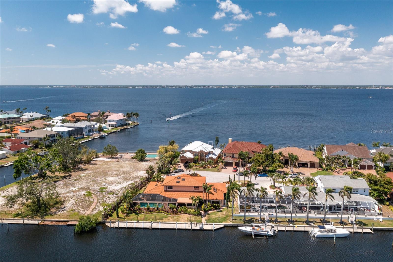 *View This BREATH TAKING VIRTUAL TOUR! *A Real Showstopper ~ *2055 JAMAICA WAY address *Magnificent Sailboat Waterfront Location In Gorgeous Punta Gorda Isles! *Immediate Access to Charlotte Harbor *127 ft Seawall with an Expansive Concrete Dock for Boating, Fishing, Sunbathing or Viewing Vessels, Herons and Manatees *Stunning Grand Foyer with Soaring Ceilings, A Truly Luxurious Custom Curved Oak Wood Staircase Takes you to the 2nd floor or Maybe you Prefer A Glass Elevator to whisk you up *Solid Wood Floors *A Chef's Dream Kitchen, Granite Counters, SS Appliances, Farmhouse Kitchen Sink *Custom Wood Cabinetry *Built in Wine Bar with Refrigeration & Bar Sink *1st Floor Master Bedroom Suite w/ Glass French Doors Opening to Extensive Lanai Pool Area! Spacious Open Concept Dining room, Living room with a Voluminous Modern Fireplace, Lit at the push of a button! *Full Custom Outdoor Kitchen *Heated Pool & Spa *Whole House Generator *And SOOO Much More... *Dolphins playing in you backyard *Live your Best Life Right Here!