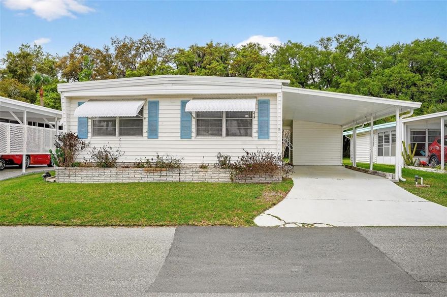 Enjoy Florida living at its finest in this 3-bedroom, 2-bathroom move-in ready home! Located in Country Club Manor, a highly sought-after, resident-owned 55+ community, this beautifully updated residence is designed for effortless living, pairing modern comfort with a low-maintenance lifestyle. Inside, a seamlessly integrated open-concept layout feels instantly like home. Bathed in natural sunlight, the living spaces flow effortlessly into a modern kitchen equipped with stainless steel appliances. You will appreciate the sleek, engineered hardwood and luxury vinyl plank flooring throughout-no carpet in sight! The spacious primary suite is a true getaway, featuring a walk-in closet, private en-suite bath, and direct backyard access. Whether you need a dedicated home office, hobby room, or cozy guest space, the two additional bedrooms provide total flexibility. Find peace of mind with recent upgrades, including: HVAC (2021), Water Heater (2024), Circuit Breaker Panel (2025). Step outside to find two attached sheds-a dedicated laundry room and extra storage space. Relax and soak in the Florida sun with NO REAR NEIGHBORS for added privacy. The low-maintenance co-op/HOA  fee covers your essentials: sewer, trash, water, AND amenities! COMMUNITY: Country Club Manor Co-op is a premier lakefront community in Eustis, featuring a plethora of amenities including a community pool, clubhouse, community boat ramp, fishing dock, shuffleboard, and more! Call to schedule your personal tour today!