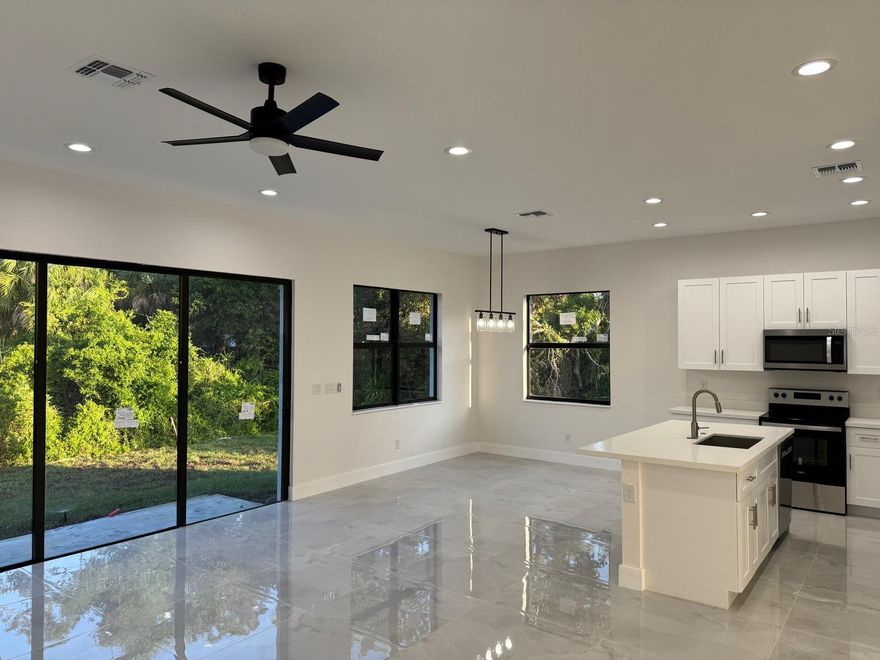 This brand-new home features 3 bedrooms, 2 bathrooms, and a 2-car garage, offering elegant living with impact windows and doors, 10-foot ceilings, and an open living-dining area. The interior showcases luxury porcelain tile floors and 6-inch baseboards throughout. The modern kitchen includes solid wood 42-inch upper cabinets with soft-closing doors and drawers, stainless steel appliances, and a spacious laundry room. The master suite offers a generous walk-in closet, an additional linen closet, and a private bath with a walk-in shower and water closet. Additional highlights include an irrigation system and water softener. Ideally located near Boca Grande and Gasparilla Island, residents can enjoy beautiful sand beaches, marinas, fishing, golf, fine dining, and shopping nearby.