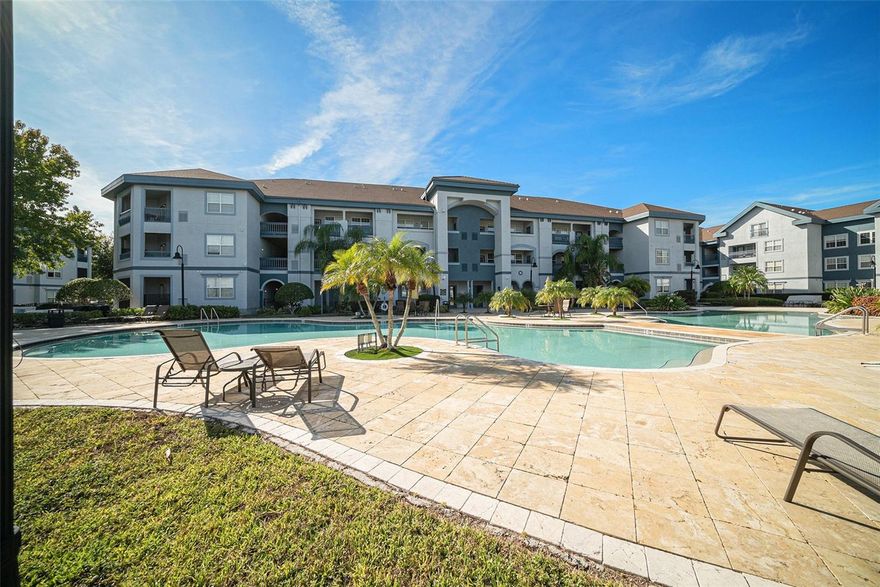 One or more photo(s) has been virtually staged. Welcome to this beautifully updated condo in the resort-style community of Tuscano at Suncoast Crossings! This unique floor plan features an open-concept layout with soaring 18-foot ceilings in the main living area, creating a bright and spacious feel throughout. The fully renovated kitchen (2018) is a true showstopper, showcasing quartz countertops, 42” soft-close wood cabinetry with roll-out drawers and a pull-out spice rack, stainless steel appliances, and a large island with additional storage and seating for three. The kitchen seamlessly flows into the dining and living areas, all finished with polished 12x24 porcelain tile flooring.Step through the French doors to your private balcony perfect for morning coffee or evening relaxation, complete with a convenient storage closet. A striking spiral staircase leads to the loft with closet and full bath, ideal for a home office, guest suite, or den. The main level features two spacious bedrooms, each with its own ensuite bath, plus a guest powder room and a hall laundry closet (washer & dryer included). Major updates include: A/C replaced in 2020, kitchen and bath renovations in 2018, and modern lighting and ceiling fans throughout.The condo fee includes cable, internet, pest control, and valet trash service for easy, maintenance-free living. Enjoy the resort-style amenities of Tuscano, two community pools (one heated), a fitness center, sauna, library, media room, and clubhouse kitchen available for events. On-site property management and maintenance staff provide peace of mind. Outdoor enthusiasts will love the direct access to the Suncoast Trail, perfect for walking, running, or biking. Conveniently located just off the Suncoast Parkway, you’ll have quick access to the Tampa International Airport, beaches, shopping, and dining.Come experience luxury, convenience, and comfort in this exceptional move-in ready condo!