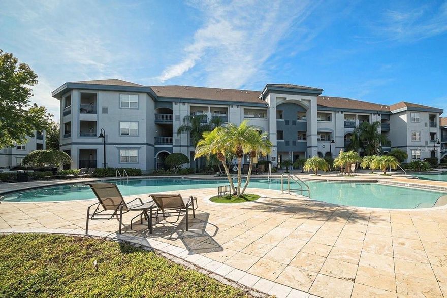 One or more photo(s) has been virtually staged. Welcome to this beautifully updated condo in the resort-style community of Tuscano at Suncoast Crossings! This unique floor plan features an open-concept layout with soaring 18-foot ceilings in the main living area, creating a bright and spacious feel throughout. The fully renovated kitchen (2018) is a true showstopper, showcasing quartz countertops, 42” soft-close wood cabinetry with roll-out drawers and a pull-out spice rack, stainless steel appliances, and a large island with additional storage and seating for three. The kitchen seamlessly flows into the dining and living areas, all finished with polished 12x24 porcelain tile flooring.Step through the French doors to your private balcony perfect for morning coffee or evening relaxation, complete with a convenient storage closet. A striking spiral staircase leads to the loft with closet and full bath, ideal for a home office, guest suite, or den. The main level features two spacious bedrooms, each with its own ensuite bath, plus a guest powder room and a hall laundry closet (washer & dryer included). Major updates include: A/C replaced in 2020, kitchen and bath renovations in 2018, and modern lighting and ceiling fans throughout.The condo fee includes cable, internet, pest control, and valet trash service for easy, maintenance-free living. Enjoy the resort-style amenities of Tuscano, two community pools (one heated), a fitness center, sauna, library, media room, and clubhouse kitchen available for events. On-site property management and maintenance staff provide peace of mind. Outdoor enthusiasts will love the direct access to the Suncoast Trail, perfect for walking, running, or biking. Conveniently located just off the Suncoast Parkway, you’ll have quick access to the Tampa International Airport, beaches, shopping, and dining.Come experience luxury, convenience, and comfort in this exceptional move-in ready condo!
