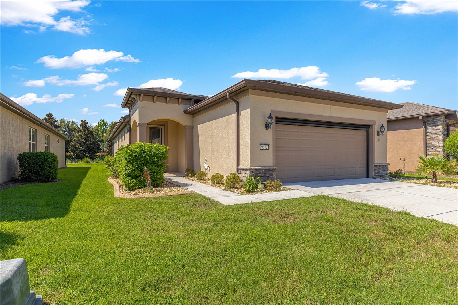 Step into this stunning Crestview model and prepare to fall in love! From the moment you arrive, the attention to detail is clear — featuring stone exterior accents, lush landscaping with decorative curbing, a custom glass front door, and a power screen for the garage.
Inside, this meticulously maintained home boasts oversized doors and wide hallways, enhancing the spacious feel throughout. The open-concept living room welcomes you in with its bright and airy design—perfect for relaxing or entertaining.
The kitchen is a showstopper, offering stainless steel appliances, granite countertops, a tile backsplash, pendant lighting, and staggered espresso cabinets that blend style with functionality. Throughout the home, you’ll appreciate thoughtful upgrades such as wood-look tile flooring, crown molding, custom ceiling fans, recessed lighting, and window treatments.
Both bathrooms feature tiled showers, comfort-height toilets, and upgraded accessible-height vanities. The primary suite includes a large walk-in closet and an en-suite bath with a spacious walk-in shower.
A dedicated laundry room with built-in cabinetry adds valuable storage and convenience. Outside, enjoy your morning coffee or unwind in the evening on the screened lanai, overlooking a beautifully landscaped backyard. A paver patio creates the perfect space for grilling or simply enjoying the peaceful surroundings. ***New Golf Cart INCLUDED with full price offer***
Additional highlights include 220-volt electric outlets, ideal for connecting a backup generator during power outages—just one of many thoughtful touches that set this home apart. Located in the highly sought-after Stone Creek community, this exquisite home is truly move-in ready. Don’t miss your opportunity—schedule your private tour today!