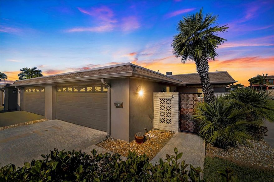 One or more photo(s) has been virtually staged. Welcome to Boca Ciega Point, a gated 55+ WATERFRONT BOATING COMMUNITY in St. Petersburg offering a relaxed coastal lifestyle just minutes from Madeira Beach and direct Gulf access. This MOVE-IN-READY waterfront villa is perfectly positioned on a PROTECTED COVE along a wide canal, tucked into a quieter section of the neighborhood where you can enjoy peaceful water views without the harsh western sun. From your private composite dock and 13,000-pound boat lift, you can be out to the Gulf in just minutes. The dock is equipped with water and electric, a catwalk for easy boat cleaning, accommodates a pontoon lift, and even offers a convenient kayak launch. Evenings here are unforgettable, with breathtaking sunsets reflecting across the water and dolphins and manatees frequently gliding by like familiar neighbors. As an END UNIT with no abutting neighbors on one side, this residence enjoys added privacy and an expansive green space alongside the home making it easier to slip around to load the boat, launch kayak, bring larger things in through French doors, or simply enjoy the extra privacy. The wide grassy common area next to the condo has been perfect for playing with grandchildren and letting the dogs run around. The wider floorplan, enhanced by a RARE 2-CAR GARAGE and double driveway, creates a more spacious feel throughout. An 11 x 23 air-conditioned and heated rear patio with a mini split brings the total living space to just under 2,000 square feet and allows for year-round enjoyment of the water views. The primary bedroom offers tranquil water vistas, while the open front patio welcomes you home with charm and curb appeal. Inside, everything has been thoughtfully updated, restored, and meticulously maintained. The kitchen features upgraded lower drawers for added function, and three solar tubes invite beautiful natural light into the home. The property is fully permitted and up to current code, with electric AFCI ARC breakers, hurricane-rated windows, shutters, and a hurricane-rated garage door protecting every opening. Additional features include a two-year-old A/C system, brand-new water heater, water softener, laundry sink in the garage, insulated patio space, and community fiber-optic readiness. Boca Ciega Point offers 24/7 gated security and an impressive array of amenities, including tennis, pickleball, bocce ball, putting green, swimming pool, sauna, fitness center, billiards room, yoga classes, card games, boating club, social club, extensive library, overflow guest parking, maintenance crew, and more. The comprehensive HOA fee of $1,312 per month includes building insurance, flood insurance, roof coverage, water, sewer, trash, cable, internet, grounds maintenance, and virtually everything except electric, delivering a truly maintenance-free waterfront lifestyle. With John’s Pass, Seminole City Center, numerous restaurants, and world-famous beaches just minutes away, this exceptional villa offers not just a home, but a way of life. Come enjoy a place that will gift you countless hours fishing off the dock or just sitting with friends, a glass of wine in hand, letting the calm wash over you.