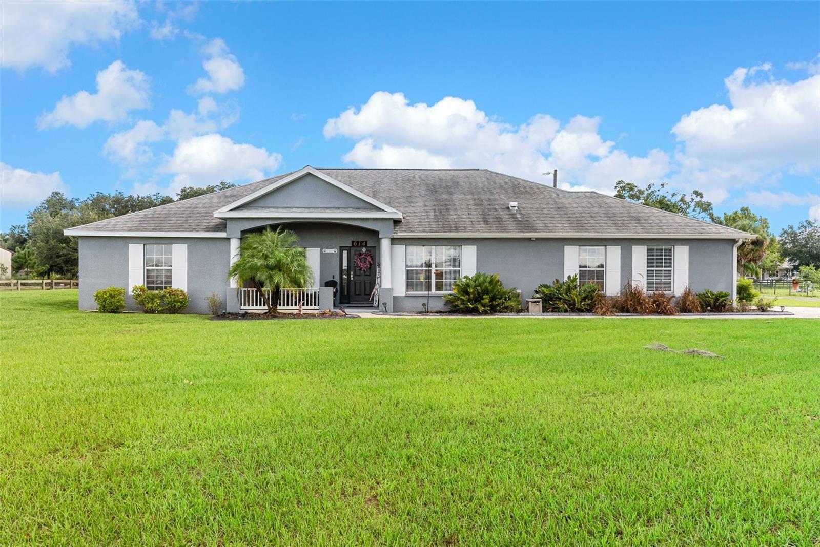 Welcome to your dream retreat nestled in the peaceful heart of Plant City! This beautifully updated 4-bedroom, 2-bathroom home
sits on over an acre of land, offering the perfect blend of country living and contemporary style. Step inside to a spacious
open-concept layout featuring elegant vinyl plank and tile flooring throughout. The split-bedroom design provides privacy and
functionality, while the warm, inviting living room boasts a real wood-burning fireplace and French doors that open to a large
screened lanai—perfect for quiet evenings or weekend gatherings. The stunning kitchen is a chef’s delight, complete with stainless
steel appliances, custom Therma-foil cabinetry, mosaic tile backsplash, crown molding, and recessed lighting. Enjoy meals at the
breakfast bar or host in the adjacent dining area filled with natural light. Your private owner’s suite is a true sanctuary, featuring a tray
ceiling, dual vanities, a garden soaking tub, and a luxurious walk-in shower with dual shower heads. Three additional bedrooms and a
full bath are thoughtfully placed on the opposite side of the home, perfect for family or guests. Step outside and fall in love with the
expansive fenced yard, mature landscaping, and peaceful surroundings. The property includes a covered screened lanai, a storage
shed, and plenty of room for gardening, play, or future projects. With no HOA, this is true freedom to live how you want. With a sizable lot, modern systems, and thoughtful outdoor structures, this property presents a rare combination of flexibility, comfort, and equity potential.