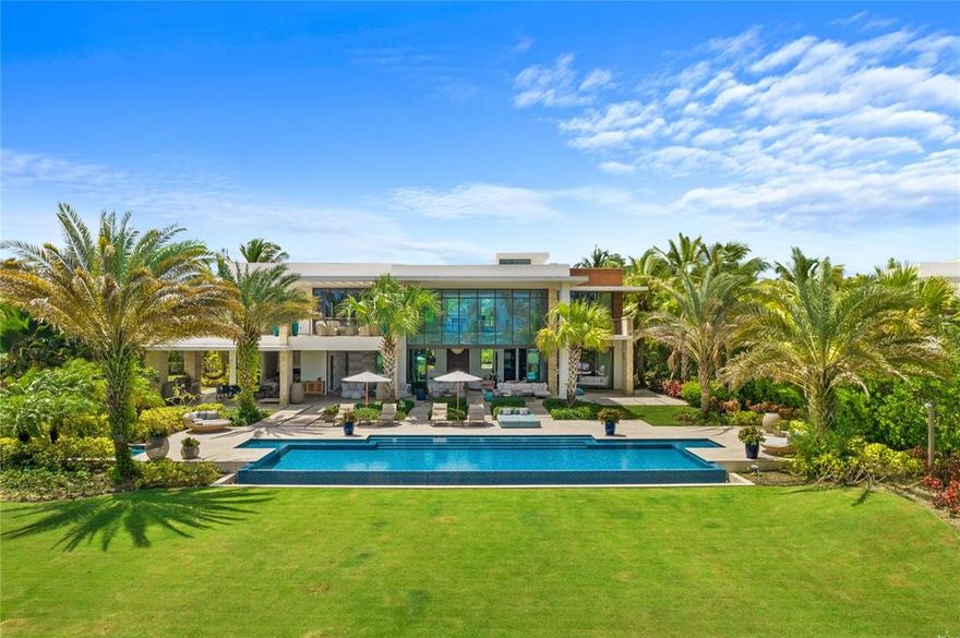 On Dorado’s most coveted street, overlooking the ocean and the rolling fairways of the golf course within the Ritz-Carlton Reserve sits an amazingly spectacular world class property.  This ultra-luxurious home boasts 12,949 sq. ft. of utmost elegance in a 1-acre ocean front lot, with 5 bedrooms plus an independent guest bedroom suite.  Distinguished by a unique modern design that beautifully combines nature and artistry, this is truly one of Dorado Beach’s most exclusive residences.
            Everything shows exquisite attention to detail in this incredibly spacious home where high ceilings and natural light abound, from its impressive foyer to the grand living room with dramatic 24 feet high floor to ceiling glass doors opening to the expansive outdoor grounds boasting an extraordinary terrace with outdoor kitchen and a pool with jacuzzi overlooking the golf course and ocean. On the main floor, the home features 2 bedroom suites, both with outdoor showers leading to the beautifully landscaped and lush green areas. The home also features a gourmet chef’s kitchen with high-end appliances (Wolf, Sub-Zero, Miele) and Poliform cabinets. The villa’s modern floor-plan is ideal for entertaining since all the common areas open to the fabulous outdoor space via sliding glass pocket doors.
A dramatic glass wall staircase welcomes you to the 2nd floor floating over a beautiful water feature. Upstairs you will find 2 bedroom suites, a 2nd dedicated laundry room, an open office space with sitting area leading to the magnificent master bedroom suite that encompasses the entire 2nd floor right wing.  The luxurious master suite has a private terrace where you can watch daily sunsets while listening to the sound of the waves plus an impressive his and hers walking closets and bathroom suite with outdoor shower.
On the main floor, home also features a mud room with half bath, an ample laundry room, a 4 car garage and 2 visitors parking spaces. 
            
East Beach Villa #7 is being sold as is and turn-key. Property was decorated in 2017 by a well-known and local interior designer.   Showings by appointment only with minimum 48 hour advance notice.  Proof of funds is required.