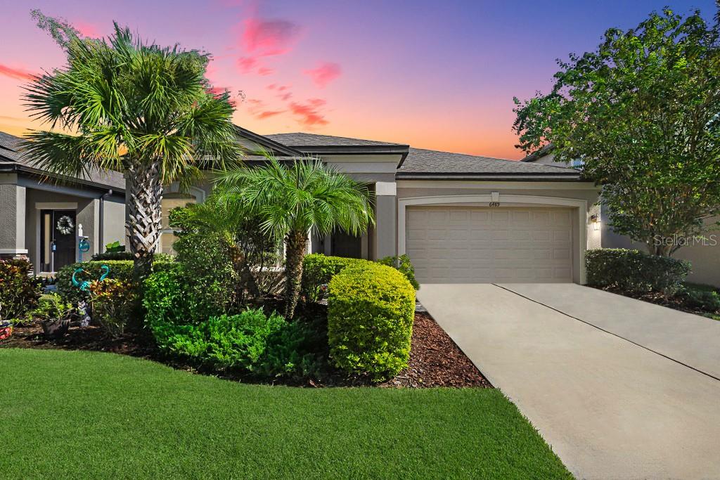 Welcome to this beautiful 3 bedroom smart home residence, located in the desirable gated community of Wesbridge. Built by M/I Homes in 2020 and move-in ready, this beautiful home captivates you with its attractive & well manicured curb appeal. Tucked away at the front of the home, two spacious secondary bedrooms share a full bathroom with granite countertops, offering comfort and privacy for guests or family. Step through the main hallway into a bright and open living area, where the kitchen effortlessly flows into the expansive gathering room and adjacent formal dining space, setting the stage for both comfort and connection. 42" espresso cabinets in the kitchen are complemented by gleaming granite counters. The kitchen features 42" espresso cabinets, gleaming granite countertops, stainless steel appliances including an upgraded French door refrigerator, a dedicated pantry, a large counter-height island with bar seating, and a cozy café area ideal for casual meals. Sliding glass doors open to your backyard retreat - the oversized lanai overlooking your lushly landscaped, fully fenced yard, offering a serene and private space to unwind at the end of your day, dine al fresco, and host those backyard BBQs. Just off the main living area, the Primary Suite offers a true sense of escape with its large walk-in closet, additional secondary closet, and a luxurious en-suite bath complete with granite-topped vanity with dual sinks, oversized walk-in shower, linen closet, and private water closet. Laundry day will be a breeze in your spacious utility room, which is located off the main hallway. Additional upgrades & notable features to this exquisite home include Arlo video doorbell and Arlo spotlight security camera in the rear of home; ClareOne home security system; Smart WiFi thermostat; Smart MyQ WiFi garage door opener; Epoxy floors in the garage; Ceiling fans throughout; Rain gutters; RainBird irrigation system; & Custom tropical landscaping including palm trees and vibrant elephant ear plants. Residents of Wesbridge enjoy access to community amenities including a resort-style pool with splash pad and slide, playground, and dog park. Zoned for highly regarded Wesley Chapel Elementary, Weightman Middle, & Wesley Chapel High School -- all within walking or biking distance -- and in easy driving distance to Saint Leo University, University of South Florida, and the University of Tampa. From local favorites to national retailers, there’s no shortage of fabulous shopping and dining nearby, including Tampa Premium Outlets, Wiregrass Mall, and Krate at the Grove. Enjoy a variety of nearby parks and recreational attractions just minutes from home, including Wesley Chapel District Park & Rec Complex, Main Event, and the Advent Health Center Ice Rink, with Busch Gardens & Adventure Island just a 30 minute drive away. Commuting and travel are a breeze with easy access to I-75, downtown Tampa, Tampa International Airport, and MacDill AFB.