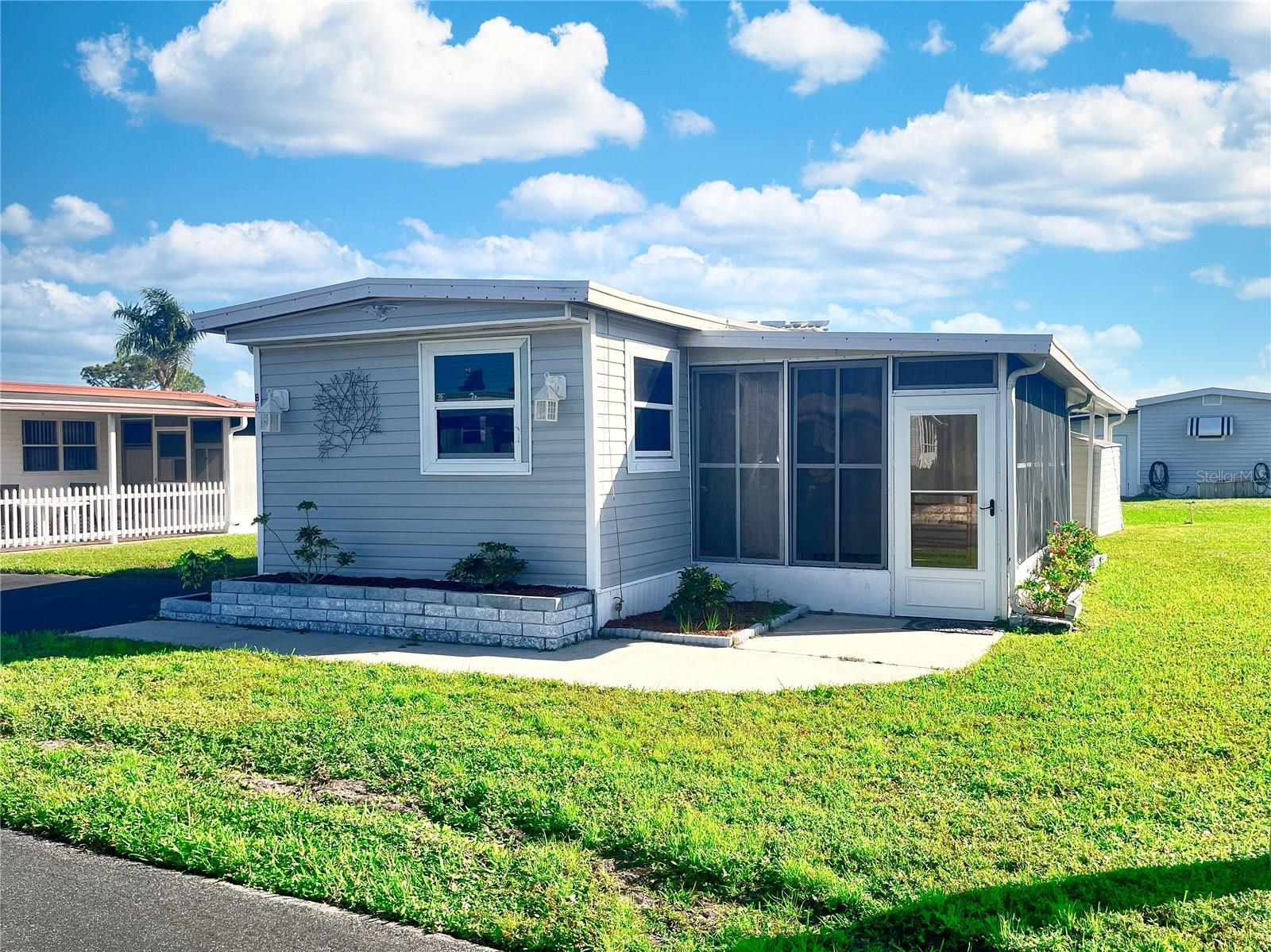 Motivated Seller...This 2 bedroom one bath single wide is priced to move. laminate wood floors throughout the entire home. Screened lanai and storage unit for extra space. Open kitchen and living area so everyone is part of the action. WestWinds Community gives you a peaceful feeling as you tour the neighborhood. Friendly smiles and waves will immediately make you feel at home and EVEN ALLOWS 2 PETS with NO WEIGHT restrictions. Numerous social activities give you a chance to meet your new friends and neighbors. With their fun scheduled activities of dinners, and Community Trips. Lunches, Card games, Shuffleboard, Boccie Ball, Billiards & Cards, Play Horseshoes, Large Heated Community pool & Hot Tub. WestWinds even has RV/Boat Storage space with special pricing for their Residents.