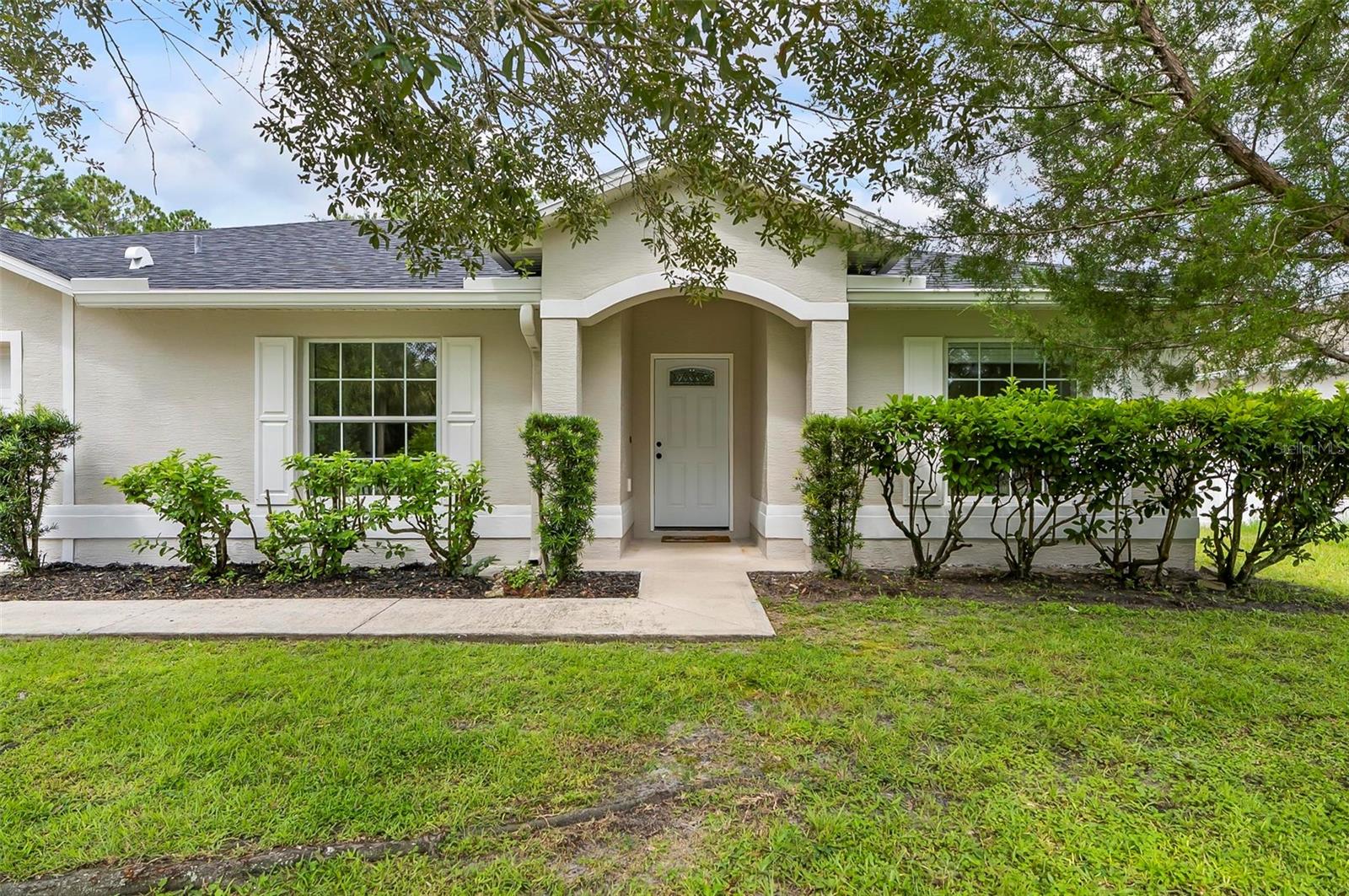 Beautifully Remodeled 4-Bedroom Home in Palm Coast with 2 bathrooms and a 2-car garage, thoughtfully updated with modern features and fresh finishes throughout. Step inside to discover brand-new flooring, a freshly painted interior and exterior, and a bright, open layout perfect for comfortable living. The remodeled kitchen boasts sleek new cabinets, quartz countertops, a convenient pop-up charging station, and brand-new stainless steel appliances. The spacious great room is flooded with natural light from two skylights, while the guest bathroom also features its own skylight. Additional upgrades include new blinds, a new water heater, and a newer roof for peace of mind. Enjoy relaxing or entertaining on the covered lanai overlooking the backyard. Located in the heart of Palm Coast, this move-in-ready home combines style, functionality, and comfort — don’t miss this one!