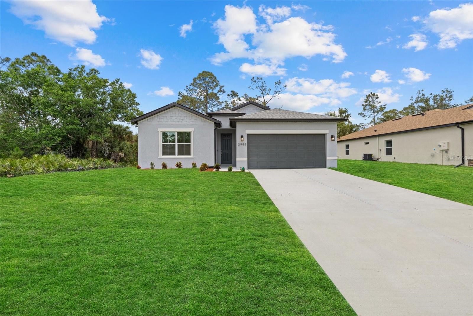 New Construction! Move-in Ready! Seller Concessions avaliable for Closing costs or Interest Rate Buy-Down. This beautiful 4-bedroom, 3-bathroom home with a 2-car garage is ready for you to call home. Step inside and be greeted by the spacious great room with soaring 9'4'' ceilings and elegant 8' doors throughout. The modern kitchen INCLUDES a stainless-steel Samsung appliance package, beautiful quartz countertops, and an open layout perfect for entertaining. The Primary bedroom comes complete with a tray ceiling, dual walk-in closets, and a spa-like ensuite with double vanities. The fourth bedroom, located at the front of the house, offers privacy with its own ensuite bathroom, perfect for guests or extended family. This home is packed with high-end finishes, including hurricane-impact windows, tiled showers, stylish and durable flooring, irrigtion system, and a Ring doorbell. Enjoy Florida living year-round on the covered lanai, ideal for outdoor relaxation. Selling concessions are available to make your move even easier! No HOA fees, no CDD. Photos are from a another home with the same floorplan and similar finishes. Schedule your showing today!