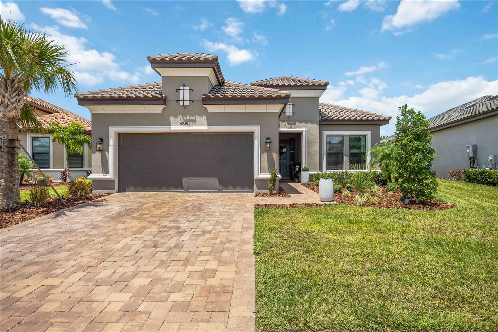 Welcome to Your Dream Lakeview Retreat Located at 4936 Caserta Court in the prestigious Artisan Lakes Esplanade—a resort-style, maintenance-free gated community in Palmetto, FL—this nearly new 1 year old Lazio model offers the ultimate in luxury living. Nestled on a premium lakefront lot, this residence showcases breathtaking sunset views and is close to the brand-new amenity center and resort pool. Outdoor Living at Its Finest, The extended screened lanai is an entertainer’s dream, complete with an outdoor kitchen hookup and panoramic views of the serene lake. The expansive lot also provides ample space for a future custom pool and spa, with a pie shaped lot that is 75 feet wide in the back. Elegant Interior Features, Step inside to a bright, open-concept floor plan with soaring 10' ceilings, elegant tray details, and 8' doors throughout. Highlights include: 3 Bedrooms + Den/Office, 3 Full Bathrooms. Luxury wood-look plank tile flooring
Two sets of sliding glass doors for abundant natural light. Chef’s Gourmet Kitchen, Designed for the culinary enthusiast with Café stainless steel appliances, 42” upper cabinets, extended island cabinetry, Cambria Quartz countertops, a farmhouse sink + island prep sink, and a gas cooktop for precision cooking. Serene Primary Suite, Retreat to your primary bedroom featuring upgraded bay windows with sweeping lake views. The spa-inspired bathroom offers a seamless glass walk-in shower, dual vanities, and a large walk-in closet for optimal storage.
Tandem 3-Car Garage, Perfect for a golf cart, extra vehicle, or additional storage, plus a spacious laundry room with utility sink adds everyday convenience. Hurricane Shutters Included. Live the Esplanade Lifestyle From lush landscaping and scenic lakes to high-end amenities and a vibrant social calendar, Artisan Lakes Esplanade offers a lifestyle like no other—designed for those who appreciate elegance, comfort, and convenience. With easy access to I-75, you're just a short drive from the Gulf of Mexico beaches, shopping, dining, and Tampa, St. Petersburg, Bradenton, and Sarasota. Experience the perfect blend of luxury and location in this pet-friendly oasis. Living in the HOA maintained community, Artisan Lakes at Esplanade means indulging in an array of amenities, including a state-of-the-art fitness center, tennis courts, pickleball courts, bocce ball, a resort-style pool with cabanas, a hot tub, and a resistance pool. Nature lovers will appreciate the walking trails, dog parks, playground, and butterfly garden. The HOA provides cable TV, internet service, and yard maintenance, ensuring a convenient and enjoyable living experience. No evacuation zone, No flood insurance required, 40 feet elevation. 2 large pools, lap swim lanes, spa, resistance pool, pickleball, tennis, bocce, shuffleboard, full fitness enter, lots of classes, clubs and events for all interests. Enjoy the best of Florida living and schedule your showing today to make this exquisite home yours. Don't miss out on the chance to immerse yourself in the resort-style living offered by the at Artisan Lakes of Esplanade