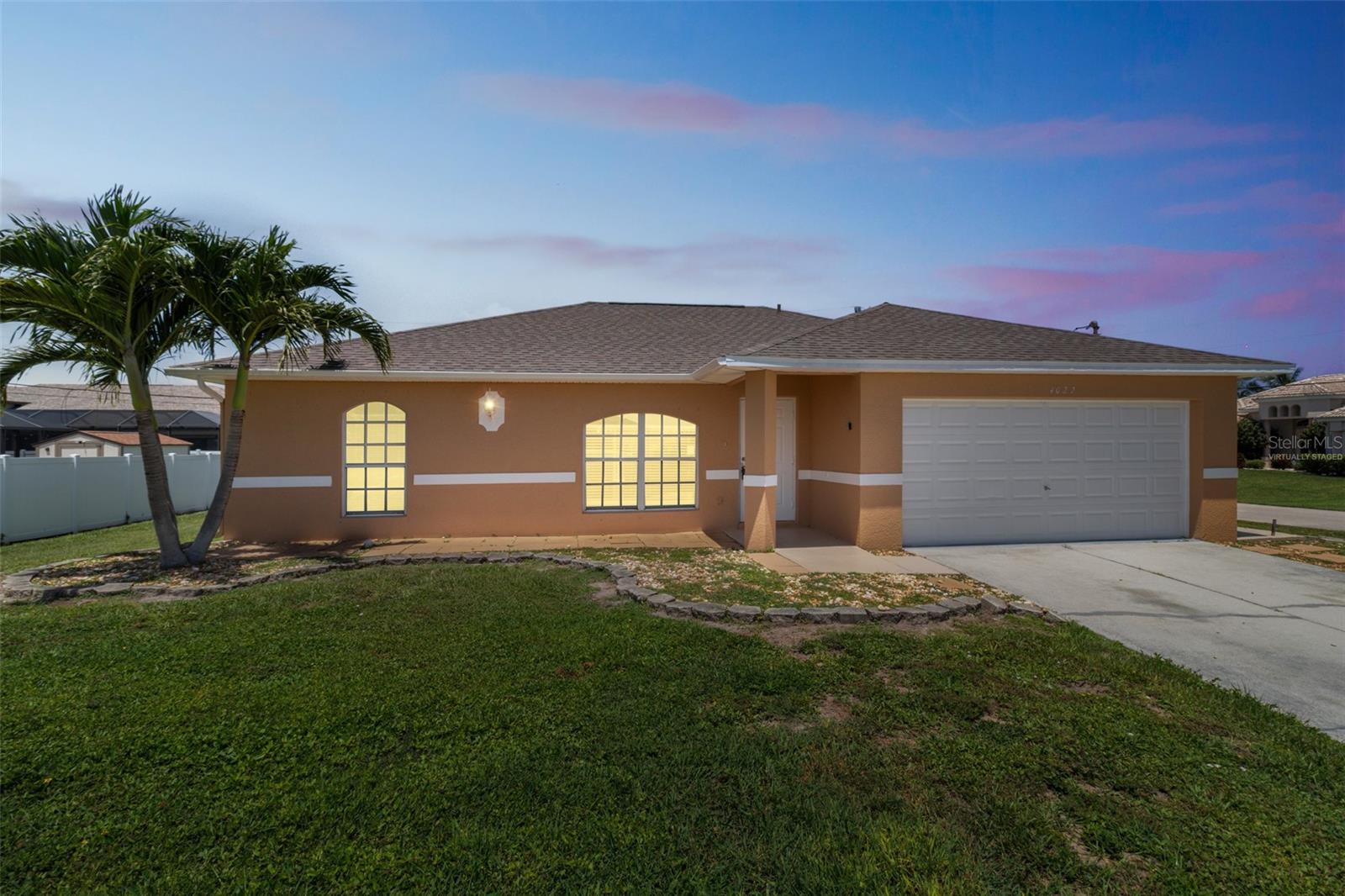 Welcome to this Cape Coral property complete with sparkling pool and screened lanai beautifully situated on a corner lot. Soak up some sun and enjoy a refreshing swim or relax in the shade on the patio. Take a peaceful stroll around the neighborhood and take in the canal views. You'll appreciate the crisp, clean feel of this updated home with vaulted ceilings and tile floors throughout giving this home an open, flowing appeal. The split floorplan preserves the privacy of the owner's suite with walk-in closet and ensuite bath. A charming den with French doors is the perfect gathering space, along with the spacious living room. 2 additional bedrooms and a second full bath round out the living space. You will certainly appreciate the separate laundry room storage and the 2 stall garage with room for your tools and storage. Just minutes from shopping, local eateries, groceries and the Caloosahatchee River.