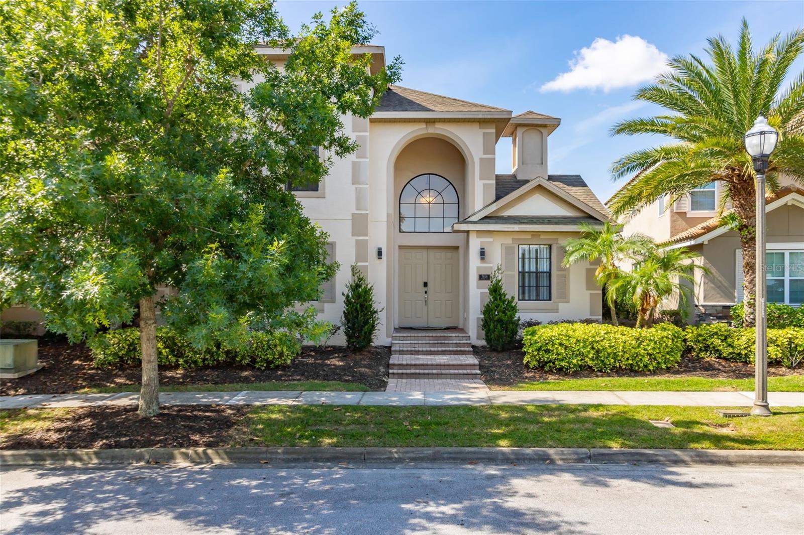 Experience resort-style living in this beautifully updated pool home, ideally situated in the heart of Reunion Resort’s sought-after Homestead neighborhood. Just steps from the community’s many restaurants, pools, and recreational amenities, this residence offers the perfect blend of luxury and comfort.
The main level features striking white porcelain tile throughout and centers around a private, heated courtyard pool with desirable south and west exposure. Sunlight fills the spacious interior, highlighting standout features in every room—from the elegant living area with a vibrant electric fireplace, to the modern island kitchen outfitted with premium energy-efficient ZLine appliances, quartz countertops, breakfast bar, and direct pool access via sliding doors.
Enjoy meals or entertaining in the stylish dining room with an adjacent sunlit sitting area. The first-floor primary suite is a true retreat, complete with a spa-inspired bath offering a rain shower, soaking tub with ambient lighting, double vanity with quartz finishes, and a custom walk-in closet with built-ins—all accented in soothing gold and white tones. A second en-suite bedroom on the main level also opens to the pool, ideal for guests or multigenerational living.
Upstairs, two additional bright and generously sized bedrooms each feature updated en-suite baths, while a versatile loft area currently functions as a gaming lounge but could easily serve as a home office or study.
This well-maintained home includes numerous recent updates such as pool resurfacing and a new deck. Offered furnished with stylish, brand-new décor (optional), the property is move-in ready—perfect as a primary residence, vacation retreat, or income-producing rental.
The HOA covers lawn care, high-speed internet, and HD cable, and residents enjoy access to Reunion’s outstanding amenities including fitness centers, pools, restaurants, and more. Located just 6 miles from Walt Disney World® and about 30 minutes from Orlando International Airport, this home delivers exceptional value in an unbeatable location.