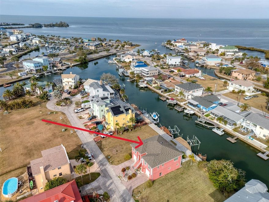 Welcome to the salt life! This ELEVATED 3-bedroom 2-bathroom home has DIRECT GULF ACCESS and INCLUDES VACANT LOT NEXT DOOR and 2 BOAT LIFTS! The 3-car garage features a workshop area and an exterior cargo elevator. As you enter this home, you'll find an open concept for entertaining your family and friends with a split bedroom plan. The kitchen features a large island with seating and STAINLESS-STEEL appliances. (NEW dishwasher being installed now) Step outside on your screened in porch for morning coffee or relax watching beautiful sunsets. The primary suite is large enough for all your king size furniture along with a walk-in closet and a full bathroom. On the other side of the home, you'll find 2 bedrooms and a full bathroom. One of bedrooms also has access to the screened in porch - perfect for your out-of-town guests. Downstairs is the 3-car garage with 15' ceilings and a workshop. There is also an office or use it as a home gym area. Step out back to the patio for grilling and entertaining and look for dolphins and manatees. Use the vacant lot next door to add a sparkling pool, outdoor kitchen or parking your boat trailer or motorhome. The possibilities are endless. This is an EXCEPTIONAL property with 110' feet of waterfront. Come live the salt life and enjoy all the Gulf life FISHING, SWIMMING AND BOATING. Hudson Beach is a small coastal town just north of Clearwater and Tampa with NO HOA! Take your Golf Cart up to small public beach and enjoy several waterfront restaurants and tiki bars. Conveniently located off Hwy 19 with shopping and hospital nearby and just 15 minutes to the expressway for easy access to Tampa and all major airports. Call me to schedule a SHOWING TODAY!