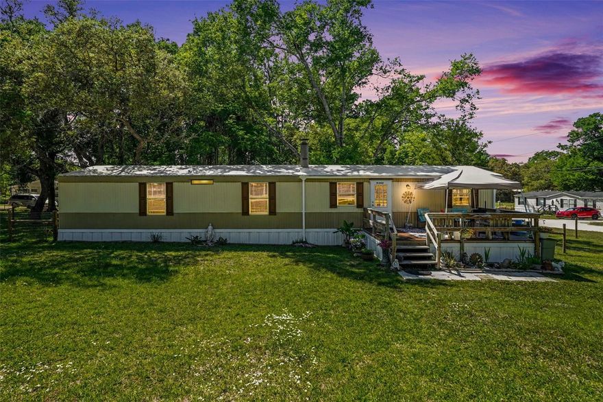 Tucked away where the pace slows and the stars shine a little brighter, this charming single-wide modular home offers the kind of peaceful country living that’s getting harder to find—and easier to fall in love with.
Set on TWO combined lots totaling .25 acres, this property gives you room to breathe, spread out, and truly make it your own. The home itself is warm and inviting, featuring a cozy wood-burning fireplace—perfect for those rare chilly Florida evenings—and newer ceiling fans that keep the air moving comfortably year-round. The roof was resealed in 2024, offering added peace of mind.
Step outside and you’ll see where this property really shines. Over the past year, thoughtful upgrades have transformed the outdoor space, including a brand-new fence, a spacious deck, and a versatile shed—ideal for storing tools, toys, or tackling your next project. The fenced area extends onto the adjacent lot (included in the sale), giving you even more usable space and flexibility.
Whether you’re sipping your morning coffee on the front porch as the sun rises, hosting weekend get-togethers on the deck, or unwinding around the backyard firepit (yes, it stays!), this home invites you to slow down and enjoy the simple things.
If you’ve been craving a little more space, a little more quiet, and a place that truly feels like your own slice of Florida countryside—this is it.