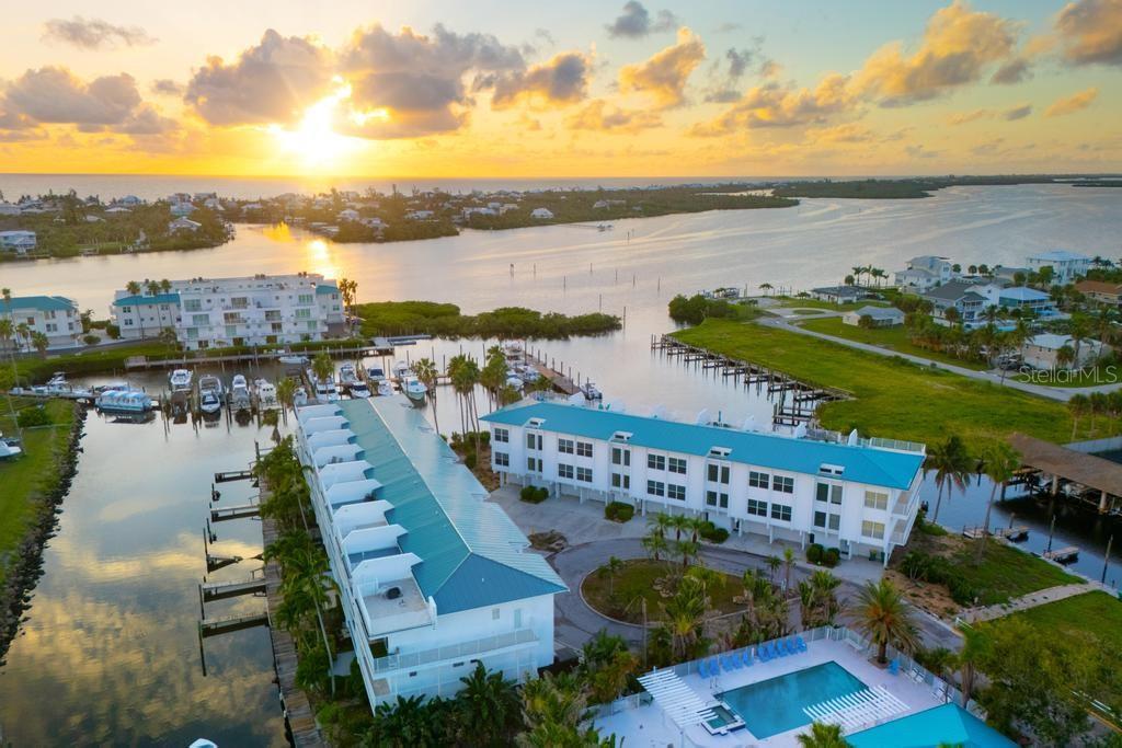 Experience coastal living at this waterfront townhouse within Cape Haze Marina Village. This exquisite residence blends incredible views with distinguished finishes, creating a warm and welcoming ambiance that makes every moment feel special.
Expansive windows and wide glass doors invite natural light and frame sweeping vistas of the marina—where boats drift past, seabirds glide overhead, and the sky transforms nightly with breathtaking sunsets. Inside, refined craftsmanship is evident in every detail, from custom cabinetry to elegant flooring and thoughtfully designed living spaces.
The open concept flows seamlessly to the outdoors, where a spacious lanai becomes your favorite spot. Whether enjoying your morning coffee with the sounds of nature, hosting friends for a waterfront gathering, or simply unwinding as the sun melts into the horizon, this home- with its balance of sophistication and ease, embodies the Florida lifestyle.
Cape Haze Marina Village is cherished for its boating lifestyle, tranquil atmosphere, and close proximity to Gulf beaches, golf, and fine dining—delivering both convenience and an enviable coastal way of life.