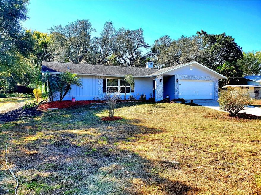 ** Palm Harbor Pool Home on Oversized Lot! **  This spacious 4-bedroom pool home sits just off Alt 19 on nearly a half-acre lot, offering plenty of room for pets and play in the 192-foot-deep backyard. No deed-restrictions or HOA fees, so bring the RV and boat if you have them!  The ranch-style home has been fully updated inside and out, featuring all-new hurricane impact windows and sliders, a 2025 water heater and A/C, and a dimensional shingle roof only 12 years old. Enjoy an incredible pool area with a vaulted screen enclosure and freshly painted pool and deck. Pool pump and filter were replaced in the last 2 years!  The open floor plan trimmed in elegant crown molding includes both a living room and family room, with the formal living space boasting glass French doors for privacy, and the family room featuring a cozy wood-burning fireplace. The heart of the home is the newly updated island kitchen with 42" cabinets, granite countertops, and all-new stainless-steel appliances (2025), perfect for the family chef, with a formal dining room nearby. The split-bedroom layout includes a primary suite with a walk-in closet and a renovated private bath featuring a granite-top vanity and tiled walk-in shower with seamless glass door. The other bedrooms have lighted ceiling fans, with the back room large enough to serve as an office or bonus space. The spacious guest bath doubles as a pool bath and has been remodeled with resort-style finishes. The 2-car garage offers a freshly painted floor, new washer (2025) and dryer, new water heater, hurricane garage door, and opener. Take advantage of the A-rated schools nearby including PH University High that is just a short drive away!  All this is in a prime Palm Harbor location, minutes from golf, beaches, and the vibrant downtown filled with shops, restaurants, and local taverns!